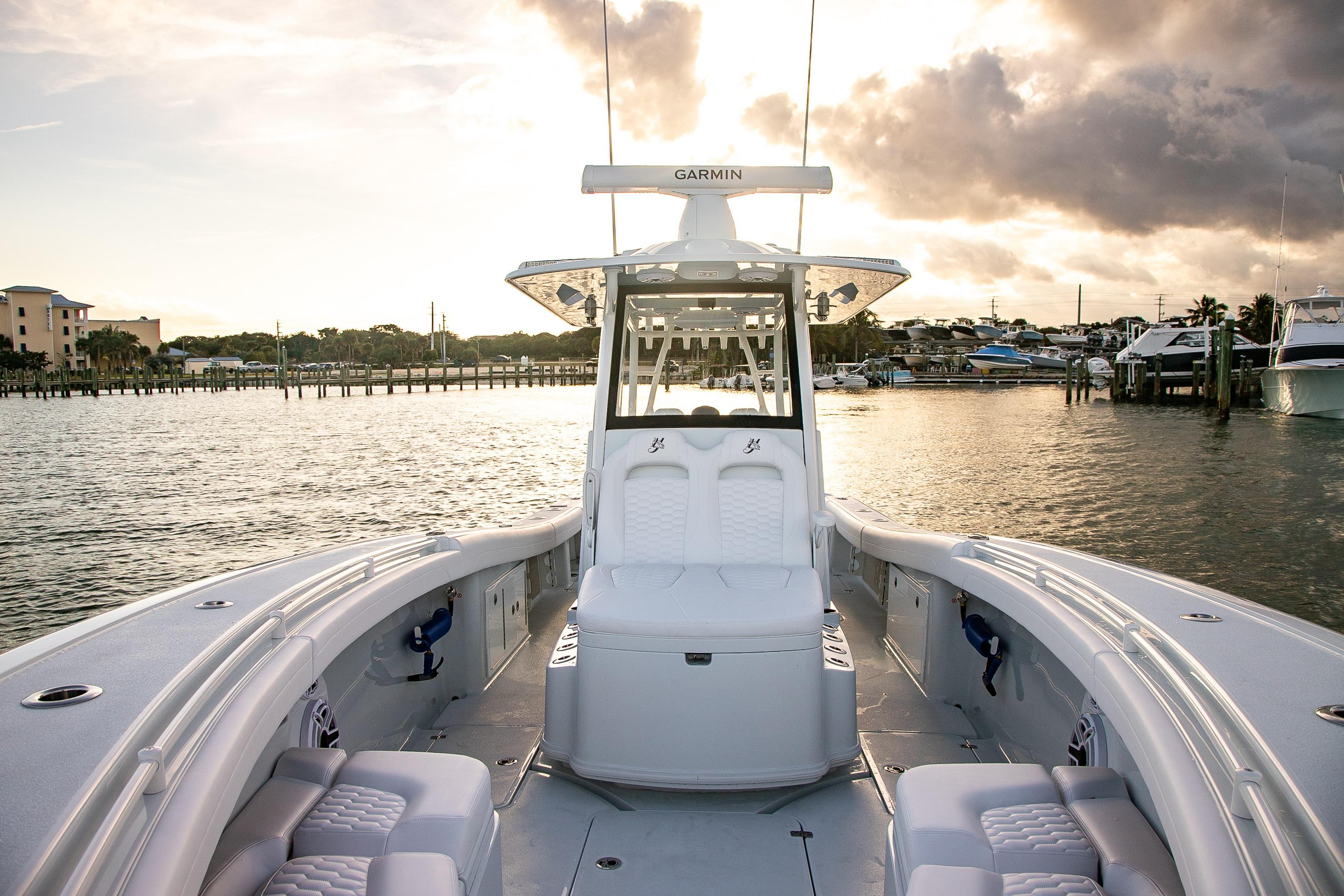 2026 Yellowfin 36 Offshore boat on calm water at sunset, featuring spacious seating and modern design.