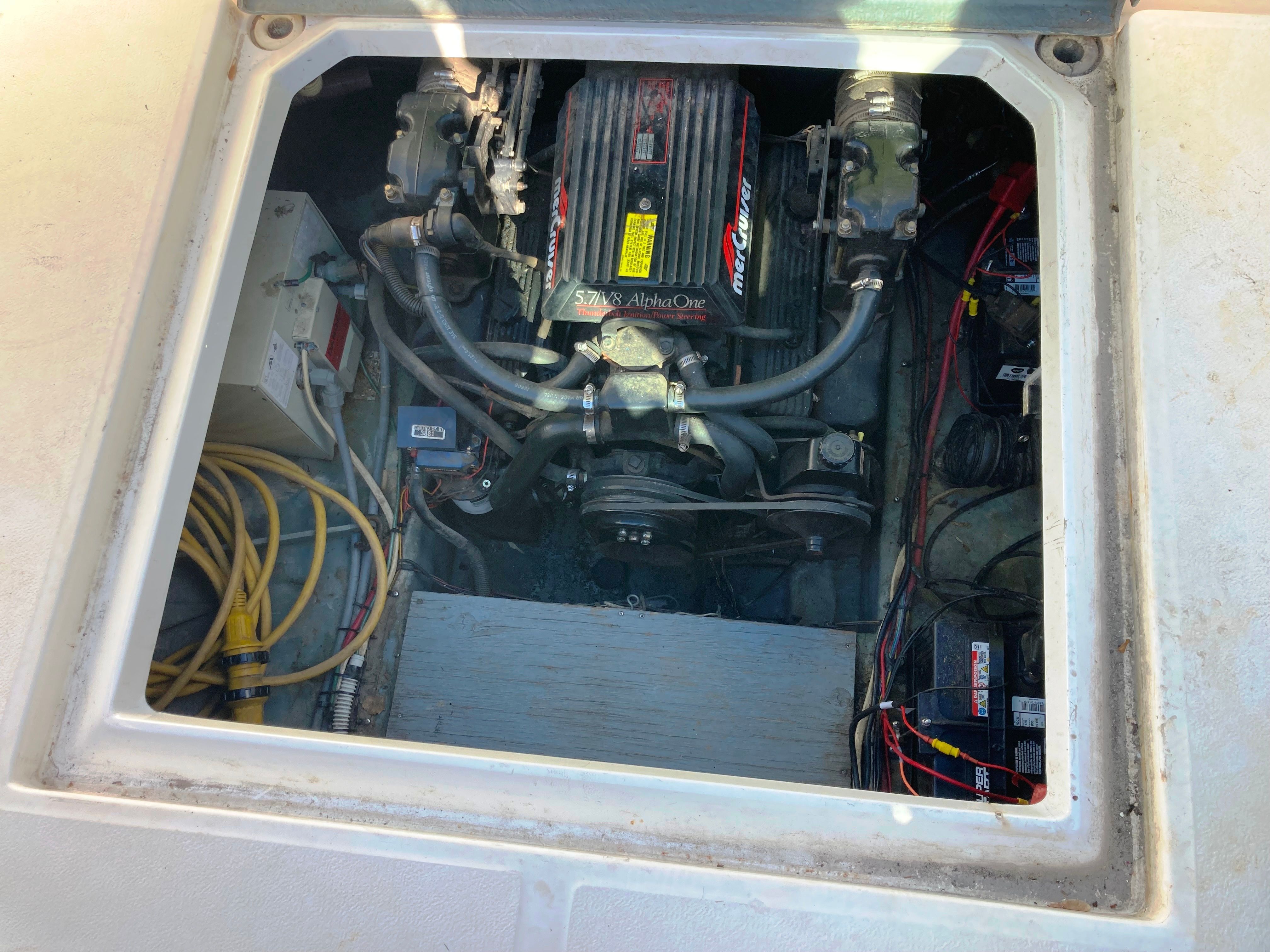 An open engine compartment of a 1991 Sea Ray 220 Sundancer showing the engine and wiring.