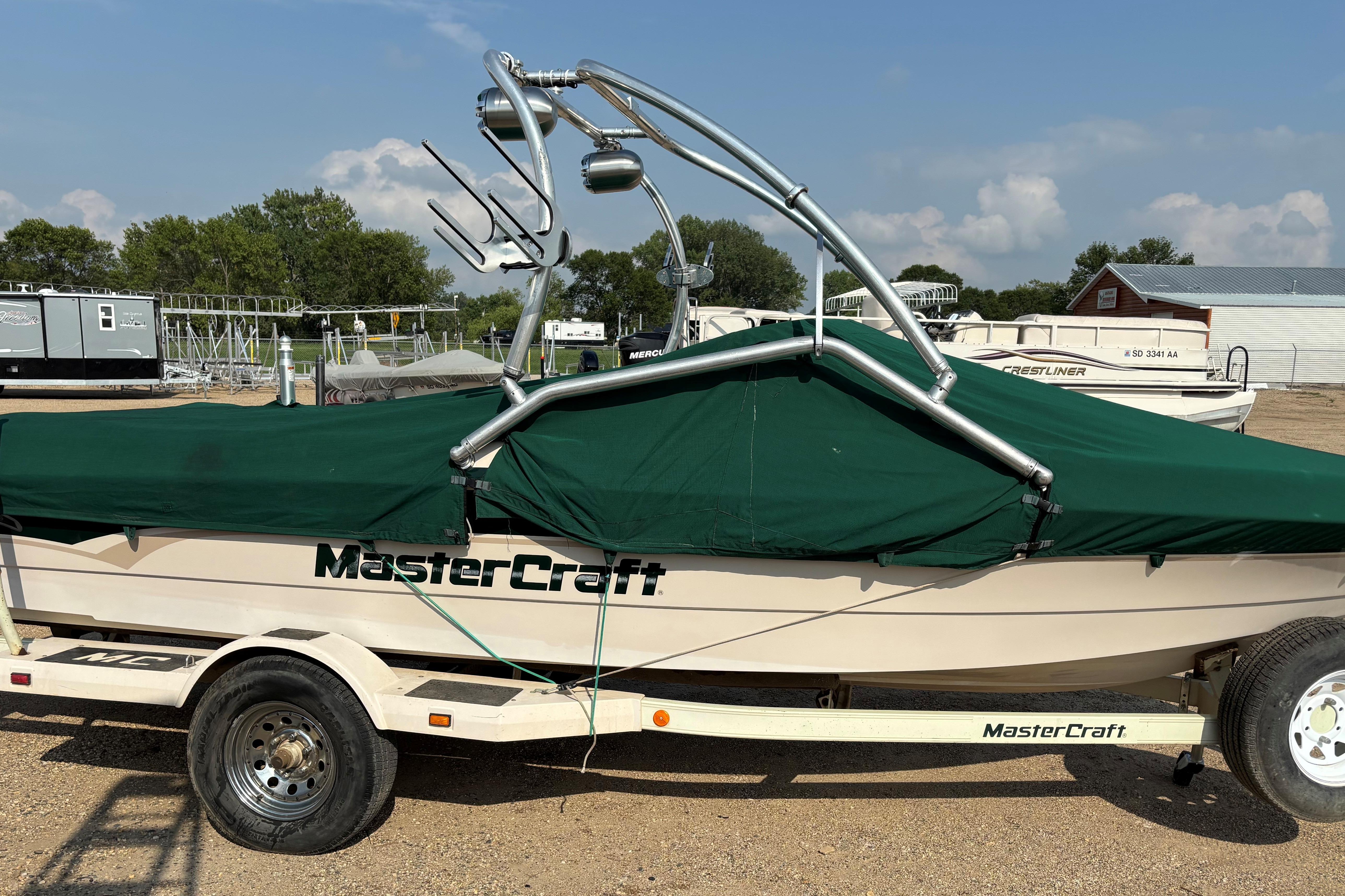 1999 MasterCraft 205 PRO STAR boat with green cover on trailer.