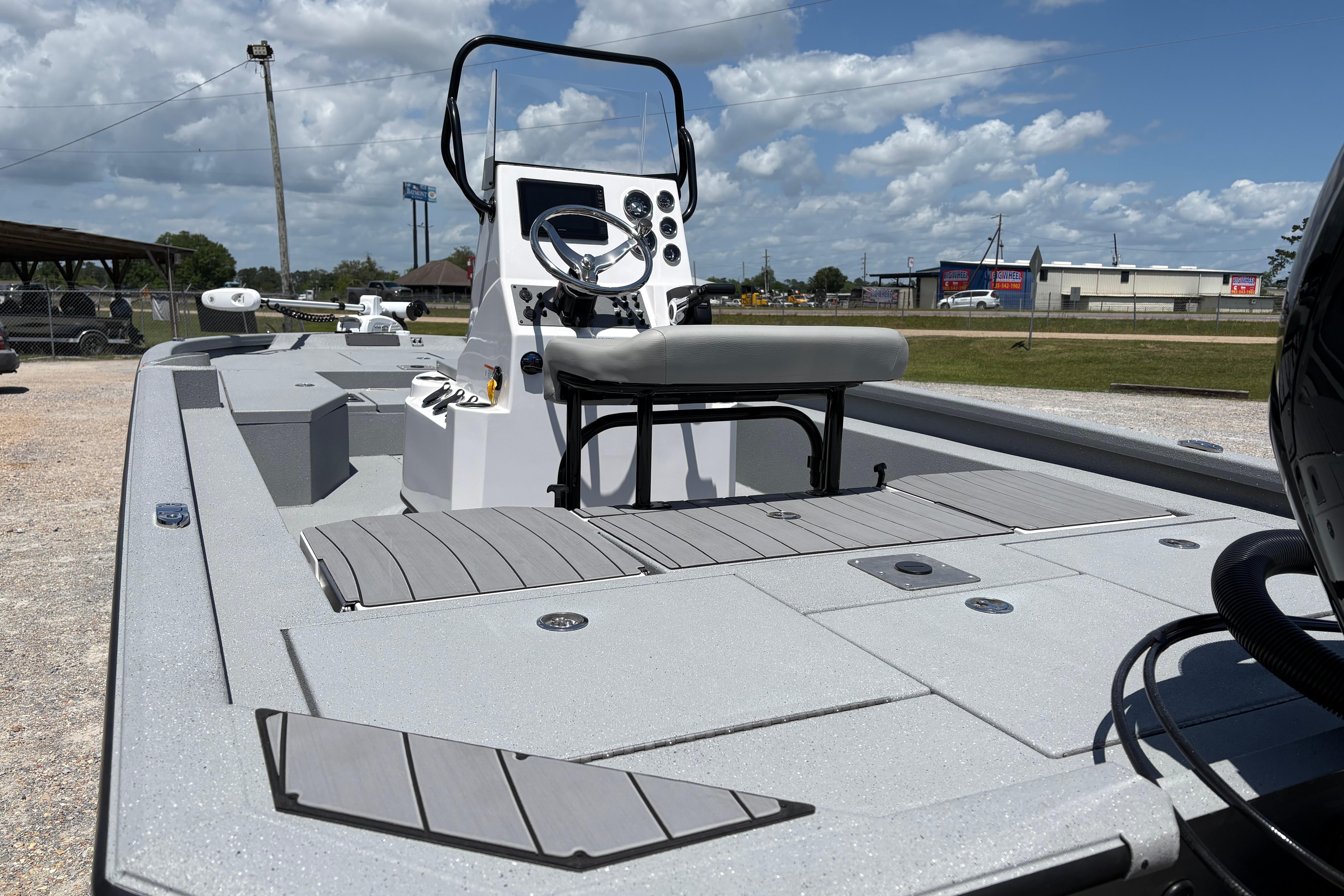 2026 Vexus ACX 2150 boat with sleek design and modern console, under a partly cloudy sky.