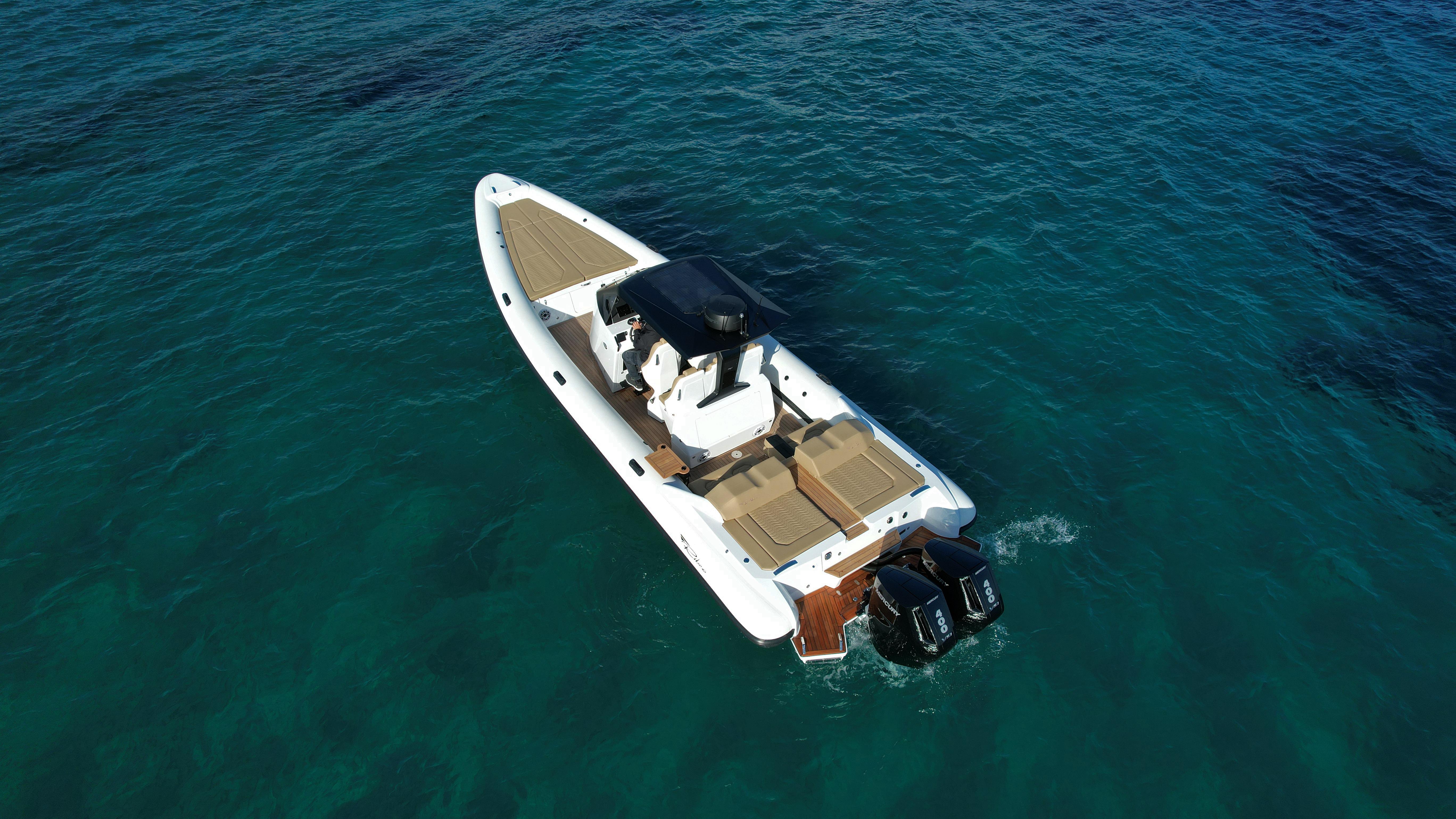 2024 Ribco Seafarer 36X boat on clear blue water, aerial view.