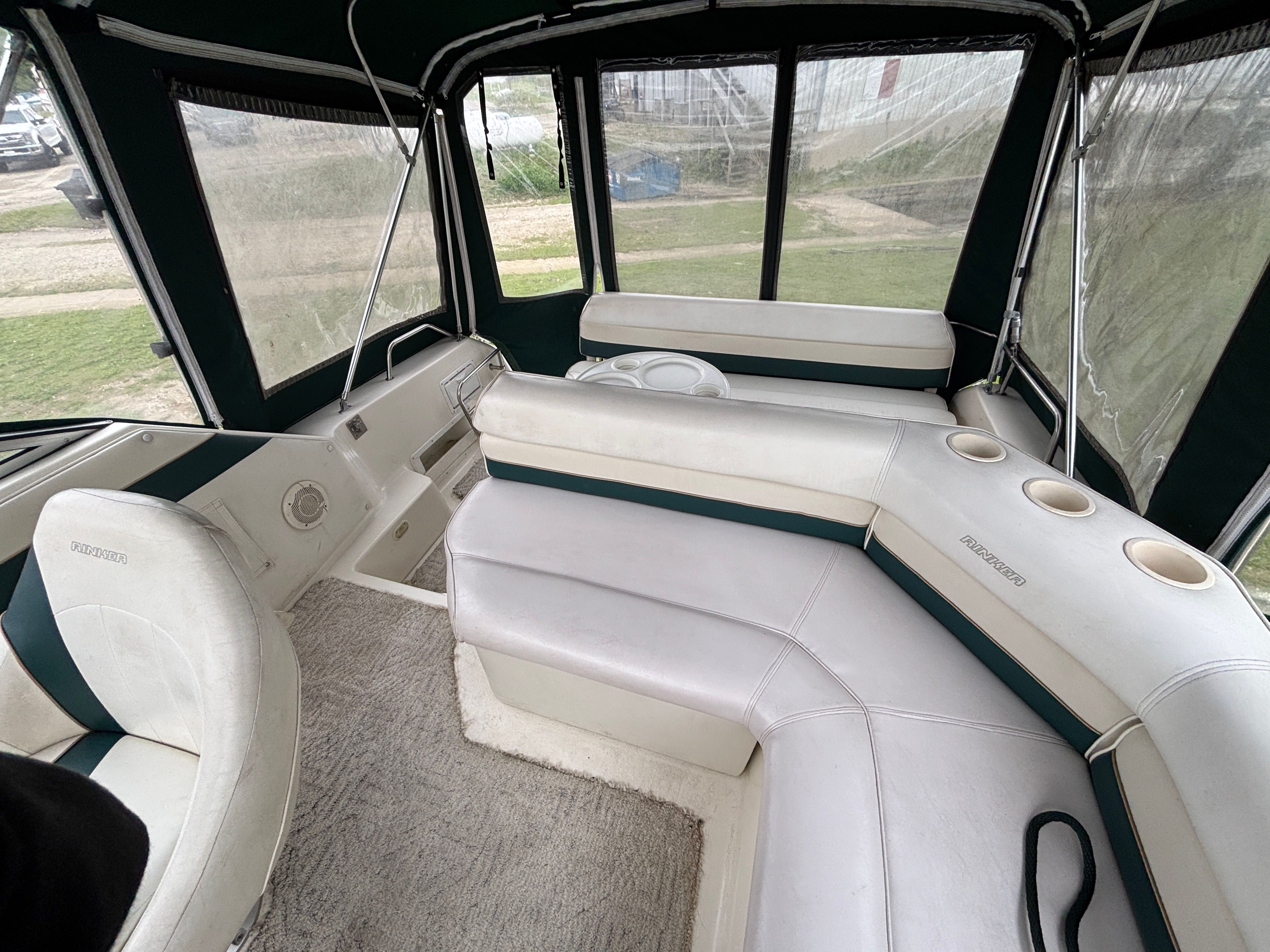 Interior of a Rinker Fiesta Vee 280 with white seating and green accents.