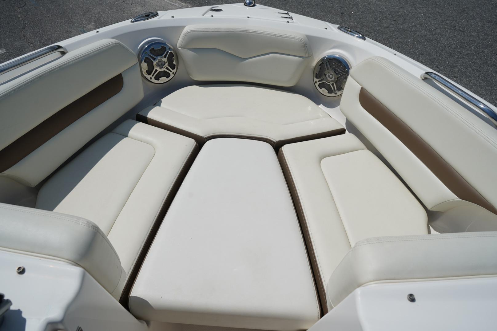 2013 Chaparral 206 SSi boat interior with cushioned seating and built-in speakers.