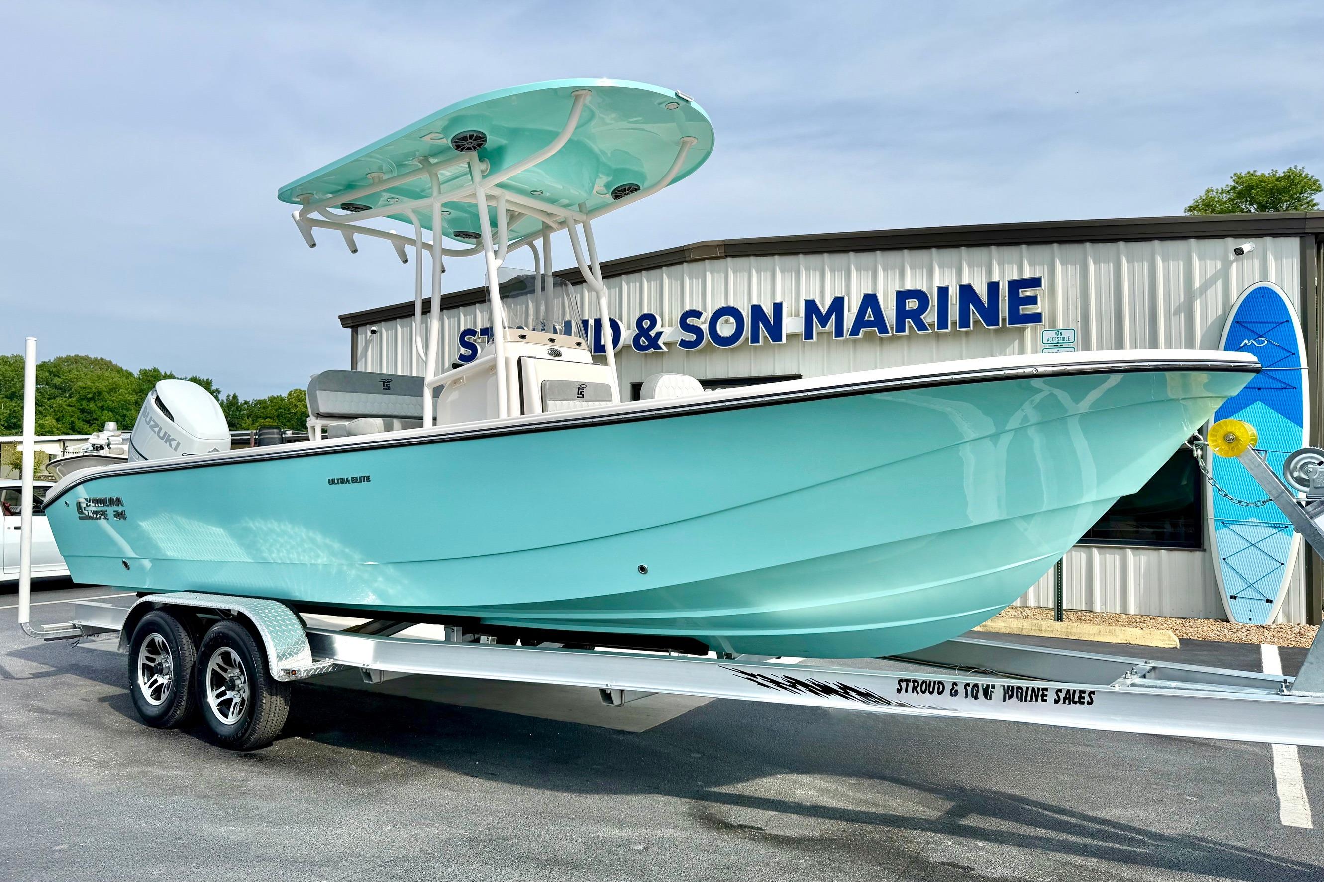 2026 Carolina Skiff 24 Ultra Elite boat on trailer at marine dealership.