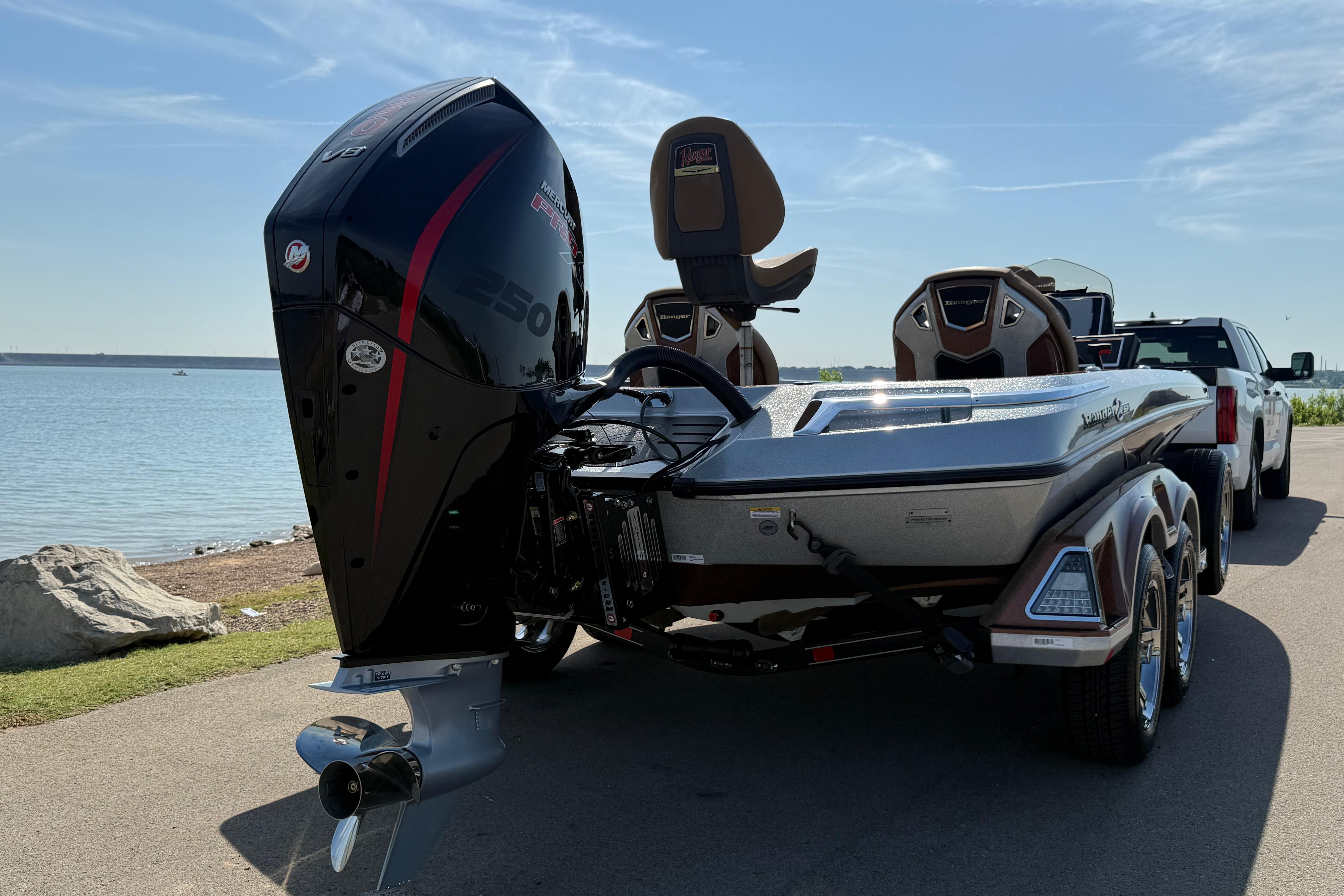 2026 Ranger Z521R boat with powerful outboard motor, parked by a scenic lakeside.