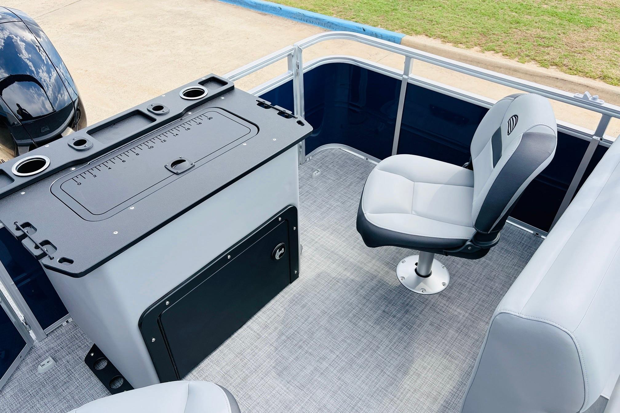 2026 Sun Tracker SportFish 22 DLX boat interior with fishing station and swivel chair.