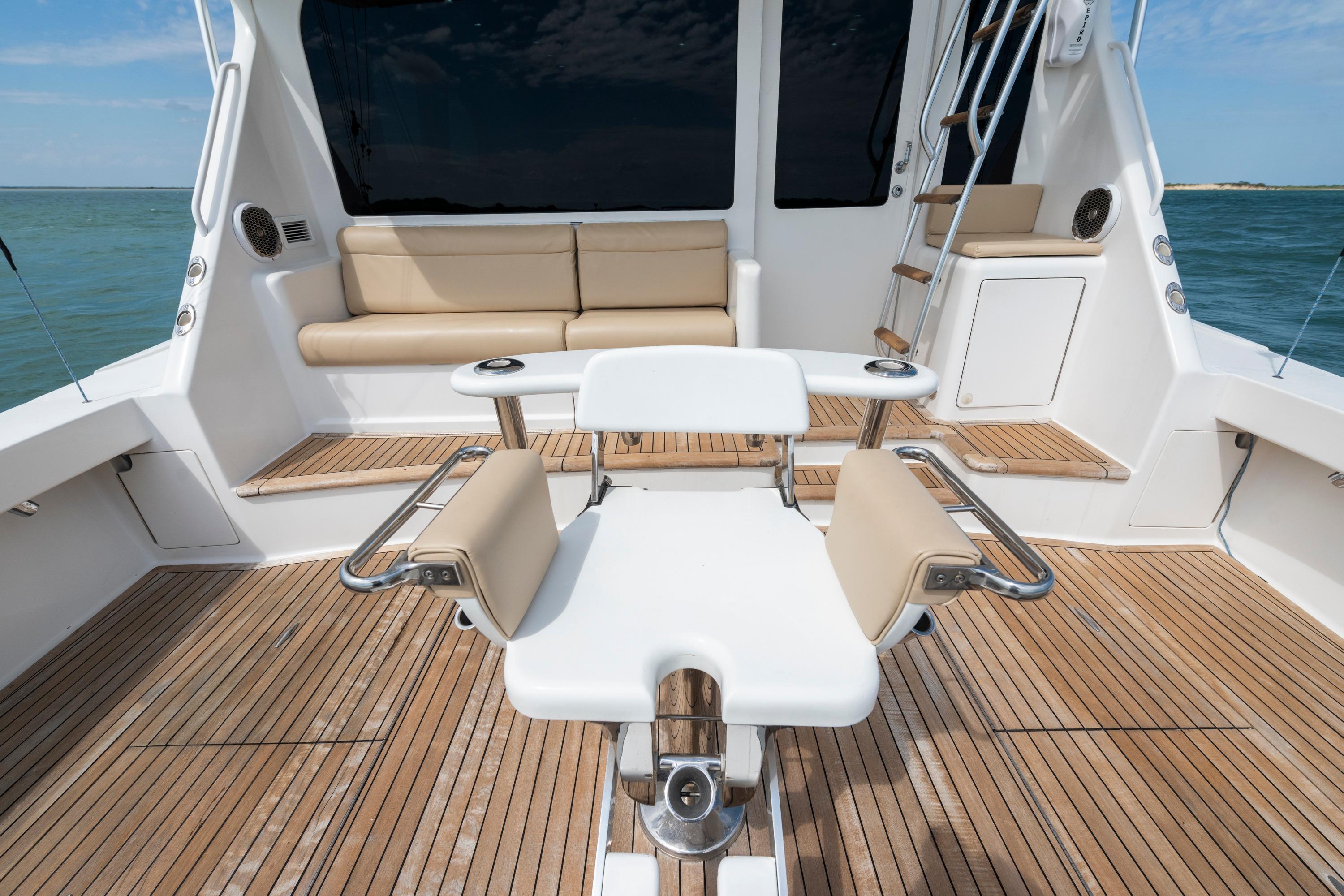 Luxurious 2009 Viking 50 Convertible yacht deck with seating and ocean view.