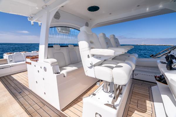 Luxurious 2020 HCB 53 Sueños yacht interior with white seating and ocean view.