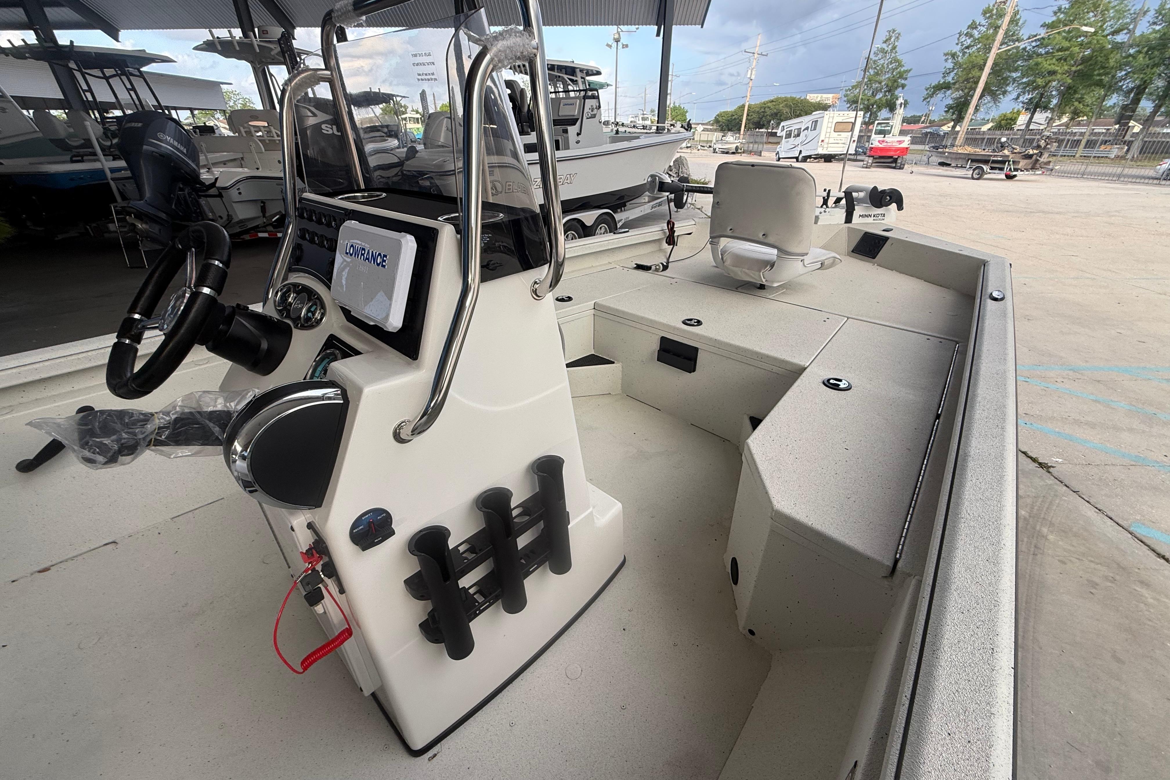 2026 Ranger RB190 boat interior with steering console and seating in a showroom.