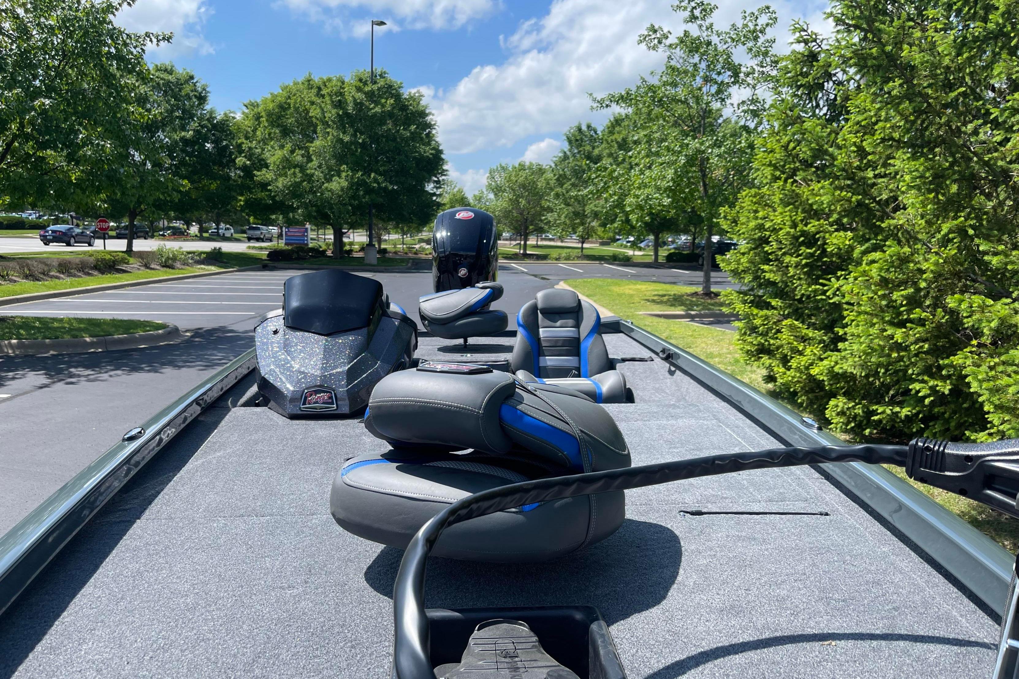 2026 Ranger RT188 boat parked, showcasing sleek design and comfortable seating under a clear sky.