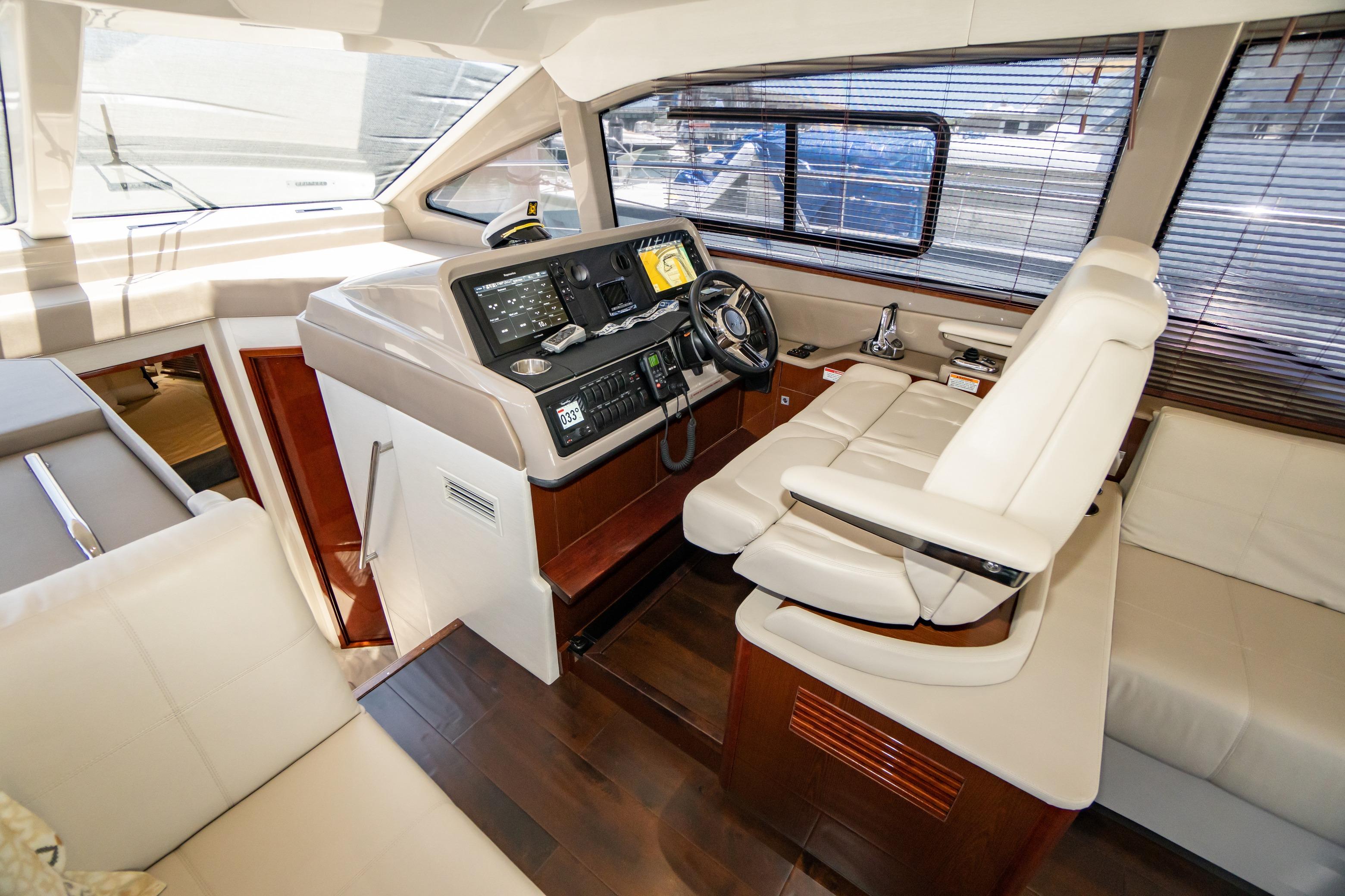 Luxurious 2017 Sea Ray Sundancer 460 yacht interior with modern helm and seating.
