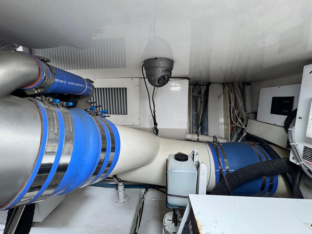 Engine room of 2007 Viking 52 Convertibles with blue hoses and wiring.