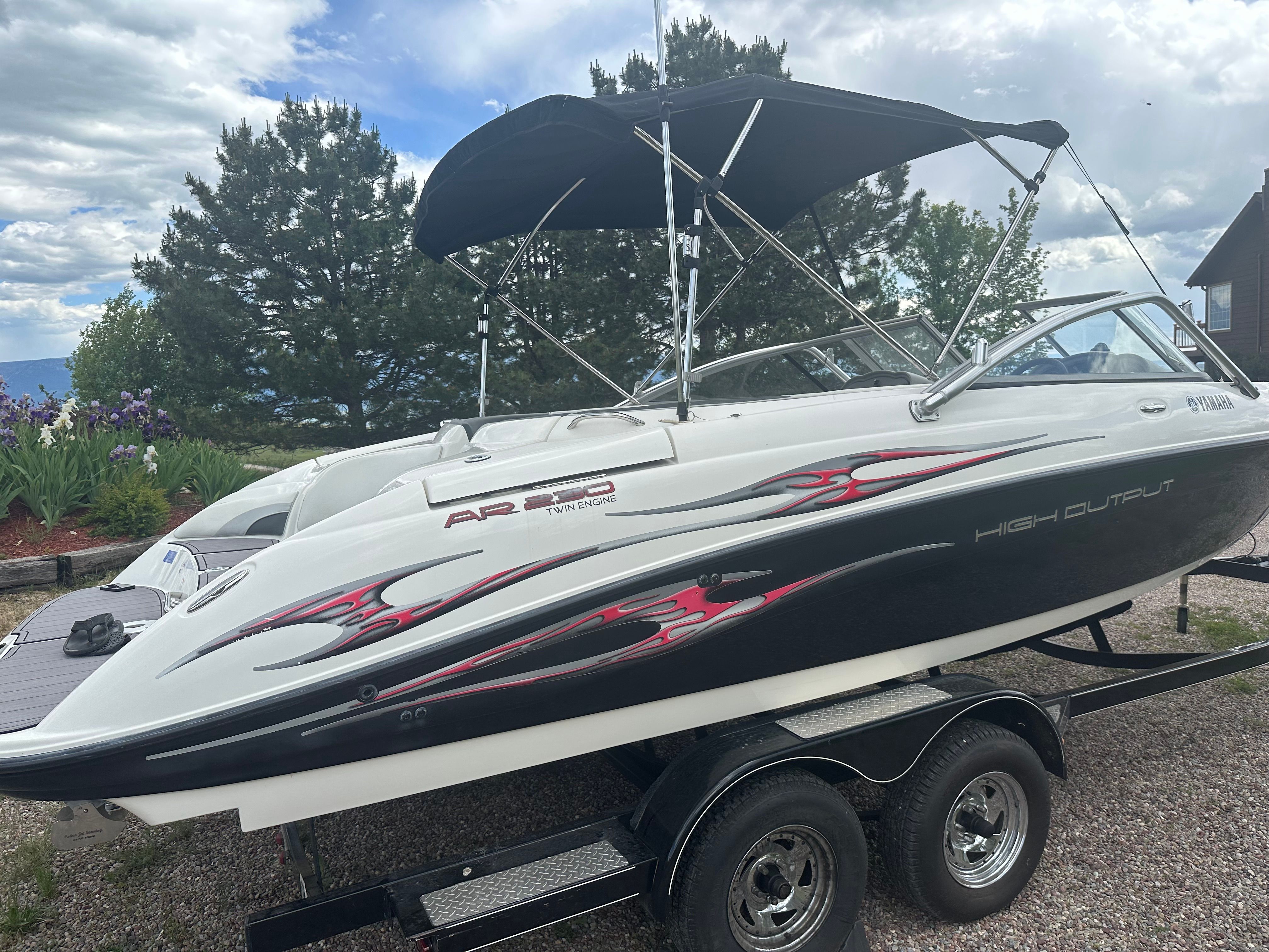 2005 Yamaha AR230 HO boat on trailer, parked outdoors.