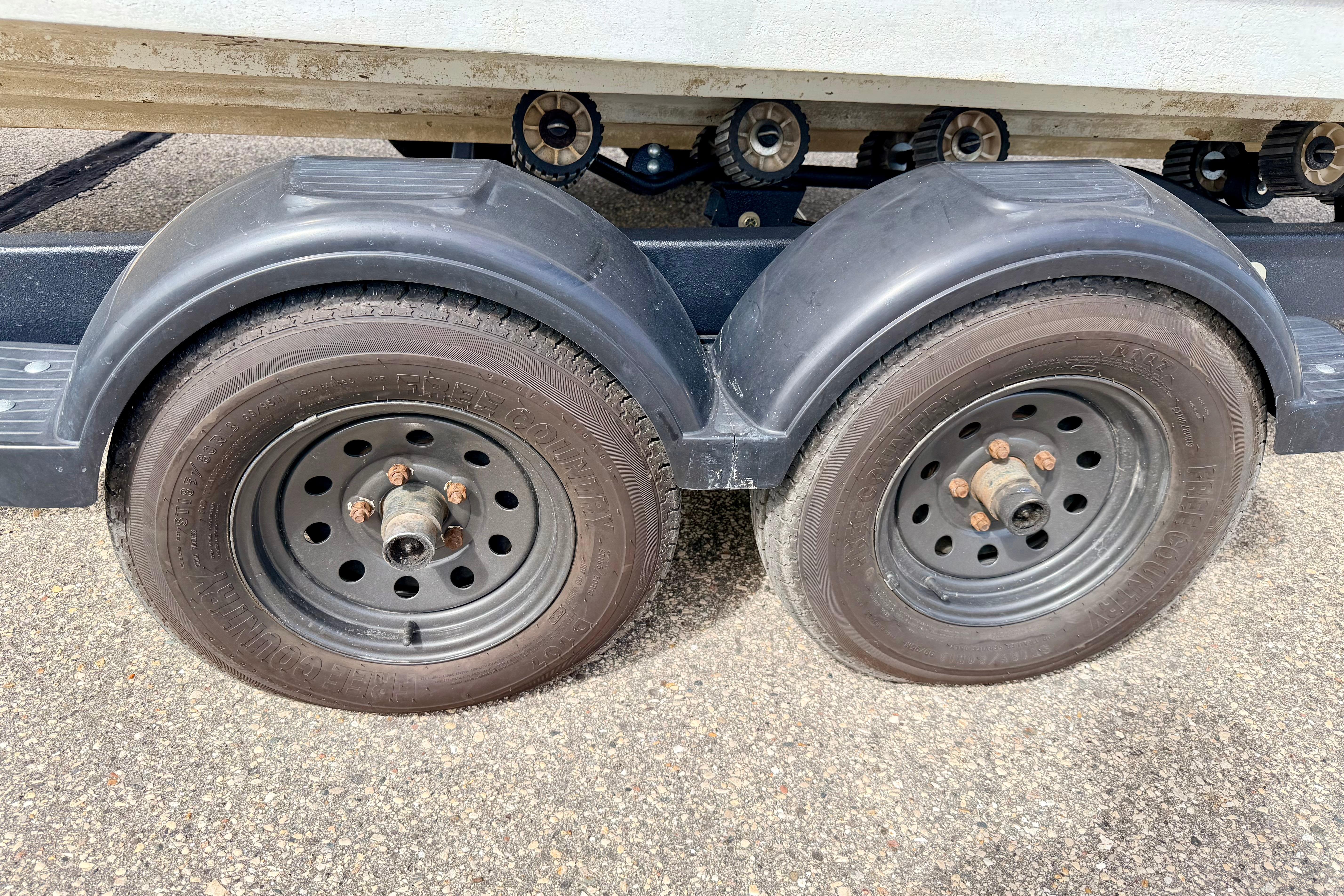 Trailer wheels for 2003 Sea Ray 200 Sundeck boat on pavement.