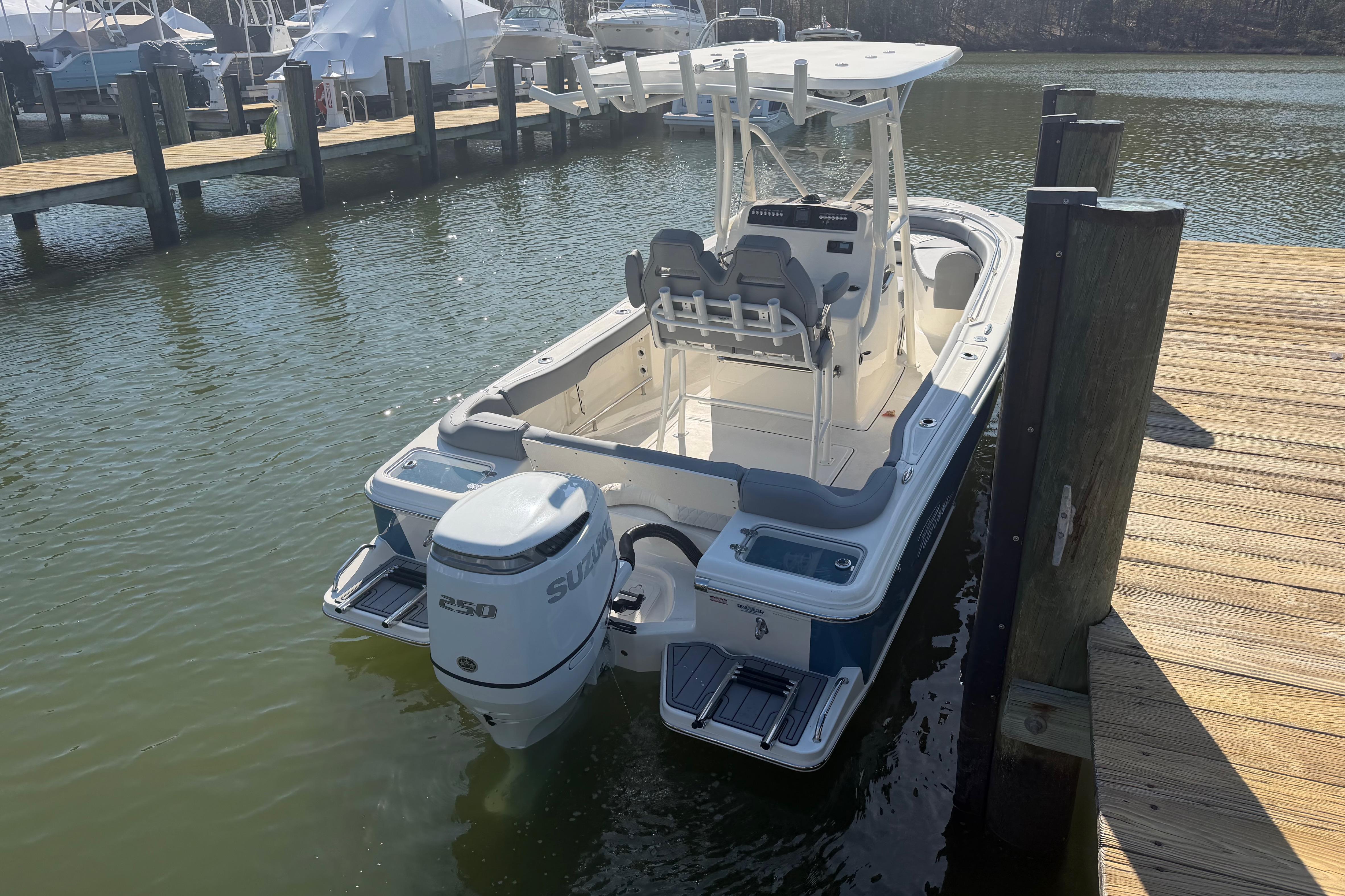 2026 Pioneer 222 Islander boat docked, featuring a Suzuki 250 outboard motor.