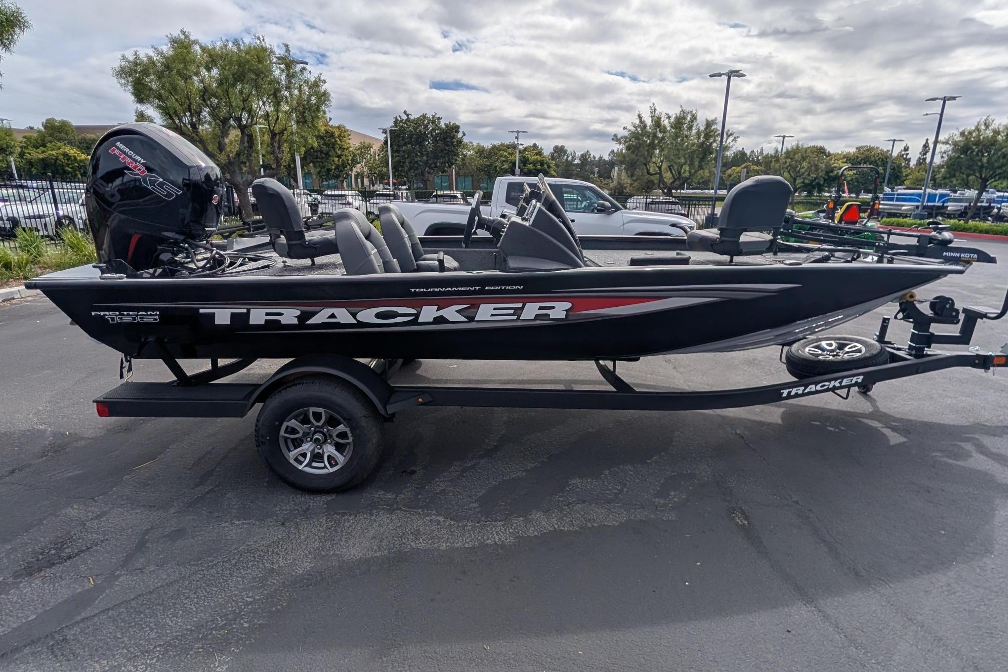 2026 Tracker Pro Team 195 boat on trailer in parking lot.