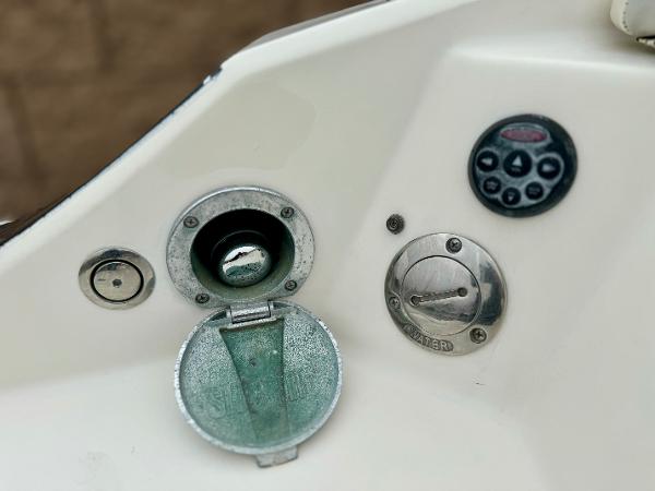 Control panel of a 2006 Larson LXi 248 boat with various switches and dials.