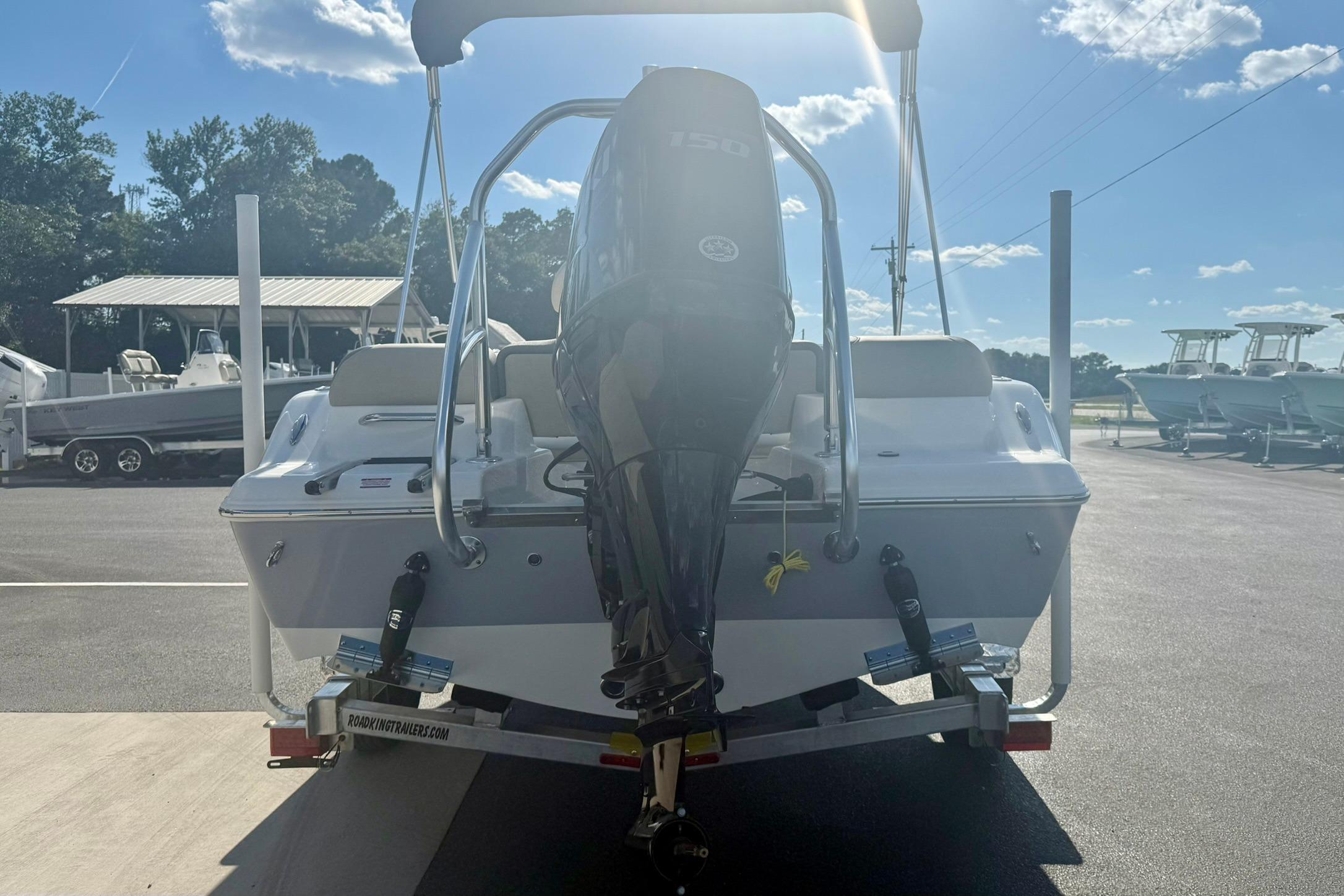 2026 Key West 189 FS boat with outboard motor on trailer, sunny day.