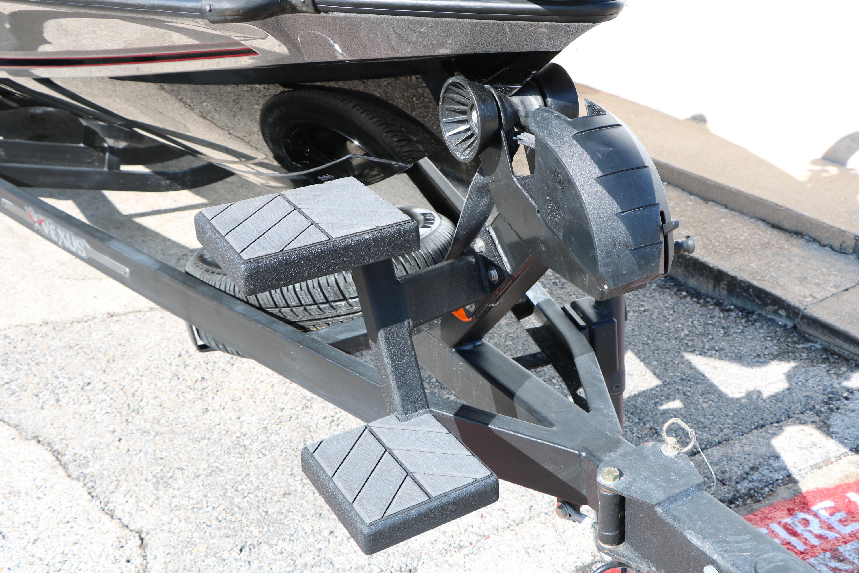 2022 Vexus VX21 boat trailer with step pads and winch, parked on pavement.