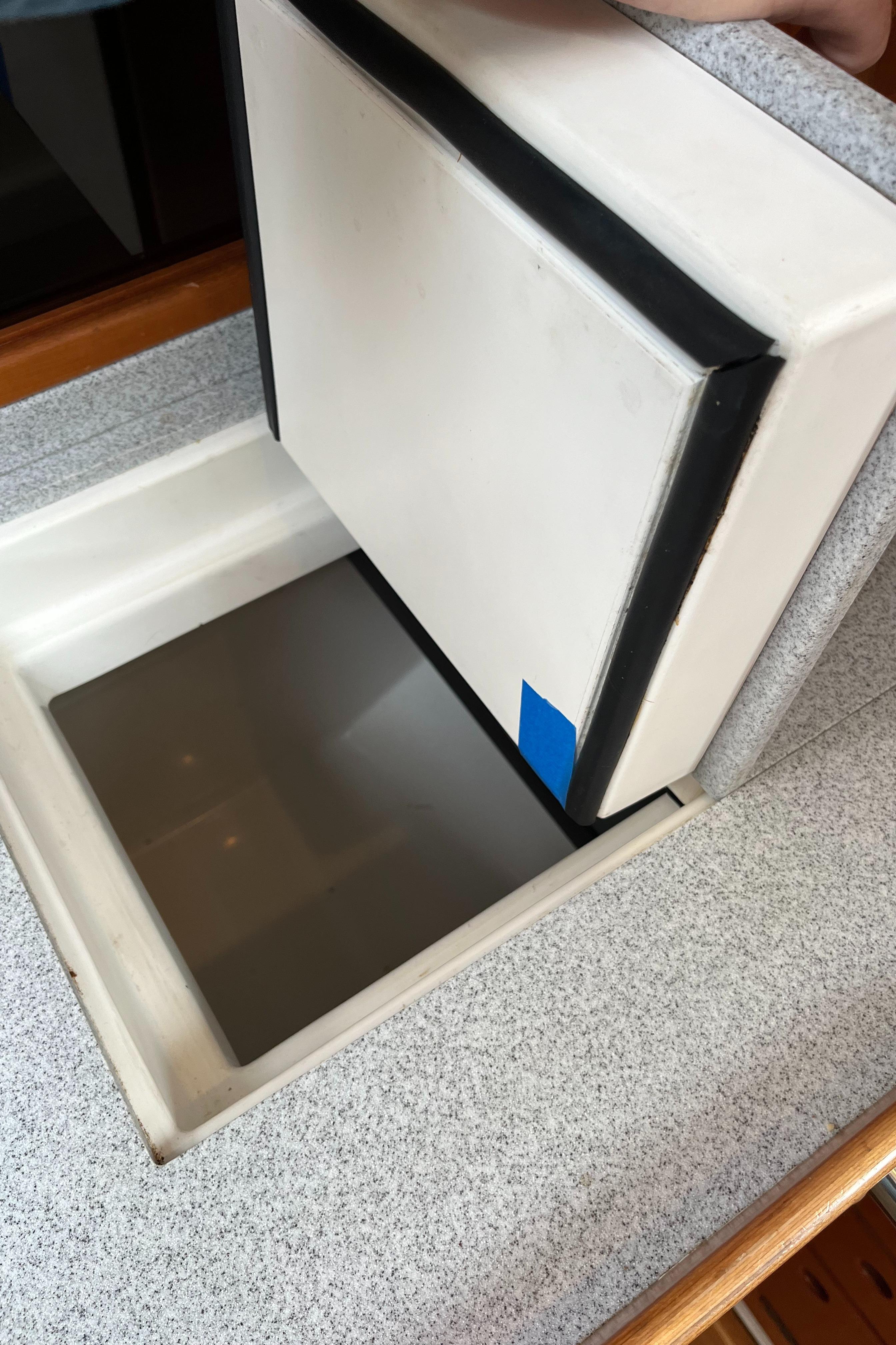 Saga 35 (2002) boat interior with open storage compartment and cushioned lid.
