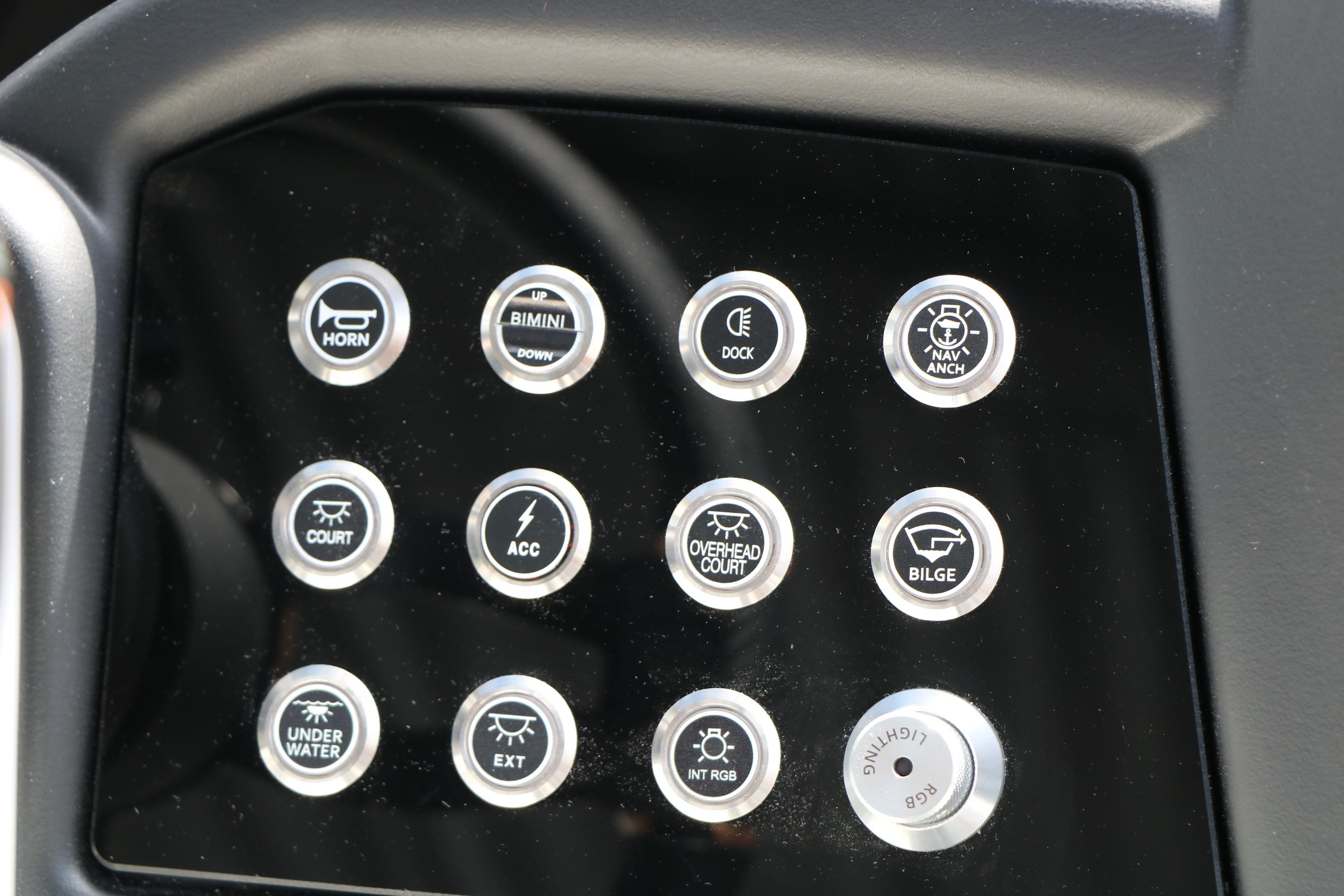 Dashboard controls of 2026 Evotti 725 CS Tri-Toon boat, featuring various function buttons.