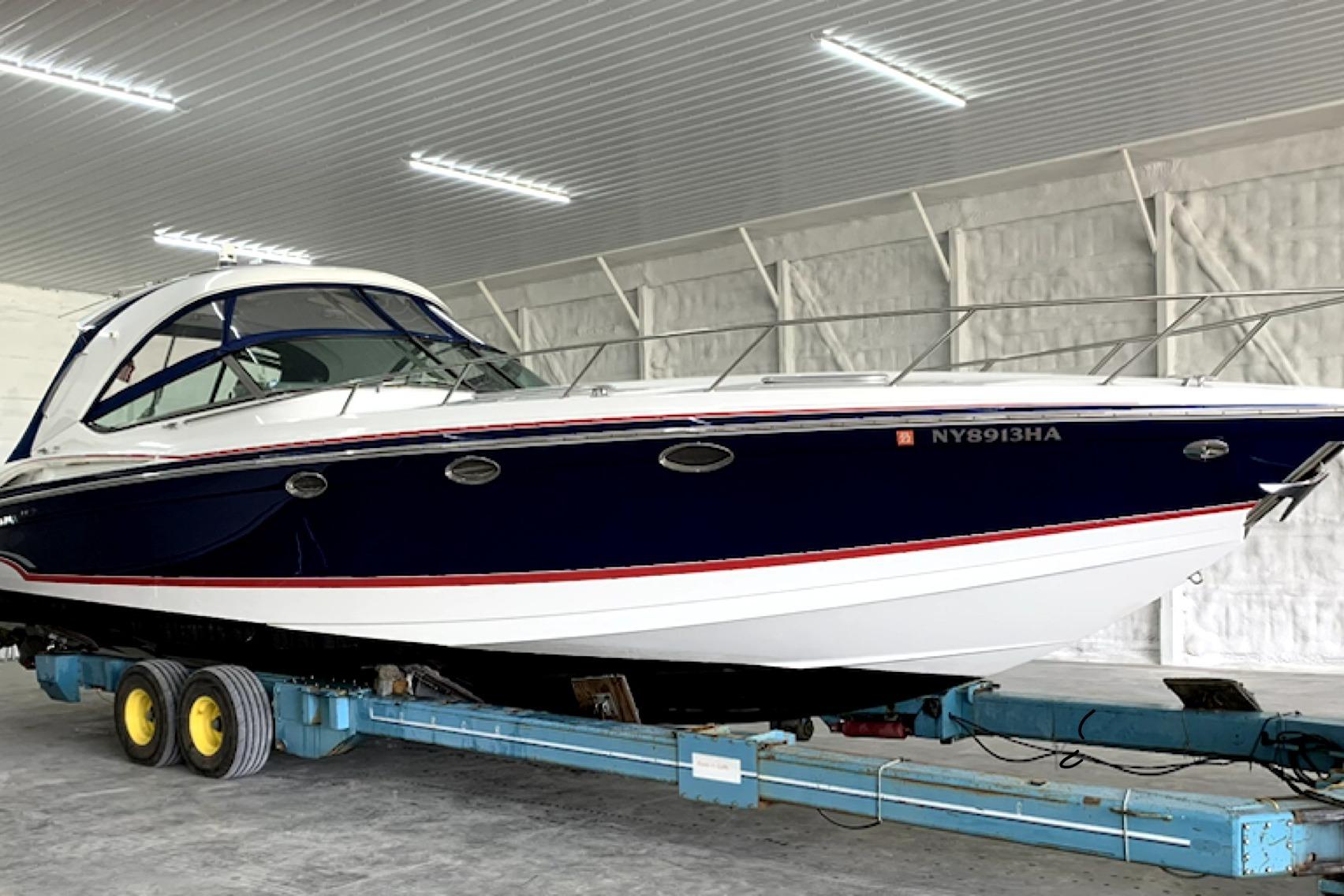 2008 Formula 400 Super Sport boat on trailer in indoor storage facility.