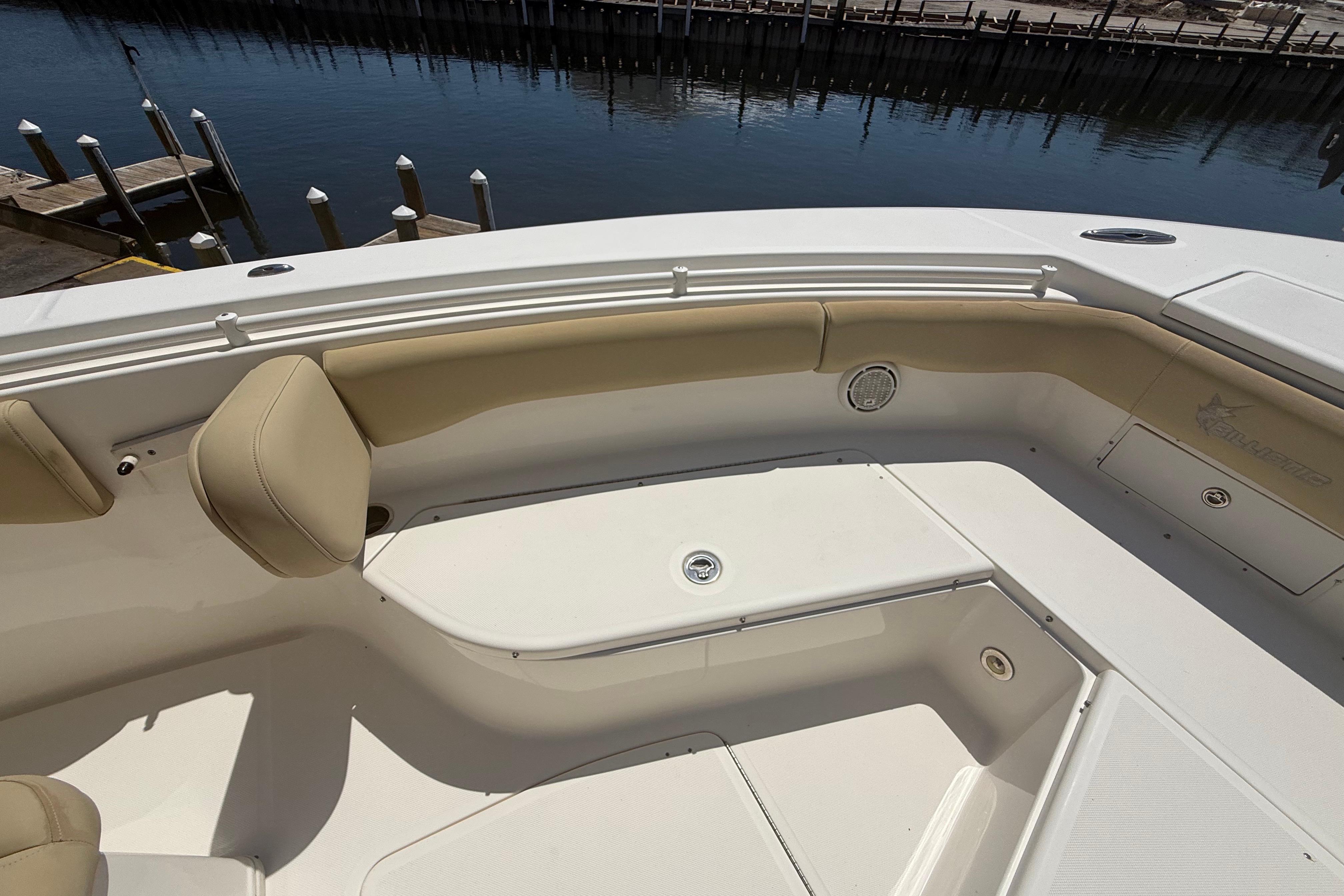 2019 Key West Billistic 281 Center Console boat interior with beige seating and storage compartments.