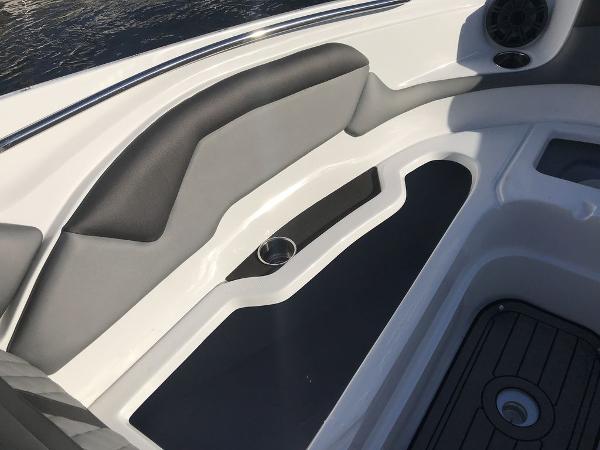Interior seating of 2020 Rinker 29QX BR boat with cup holder and speaker.