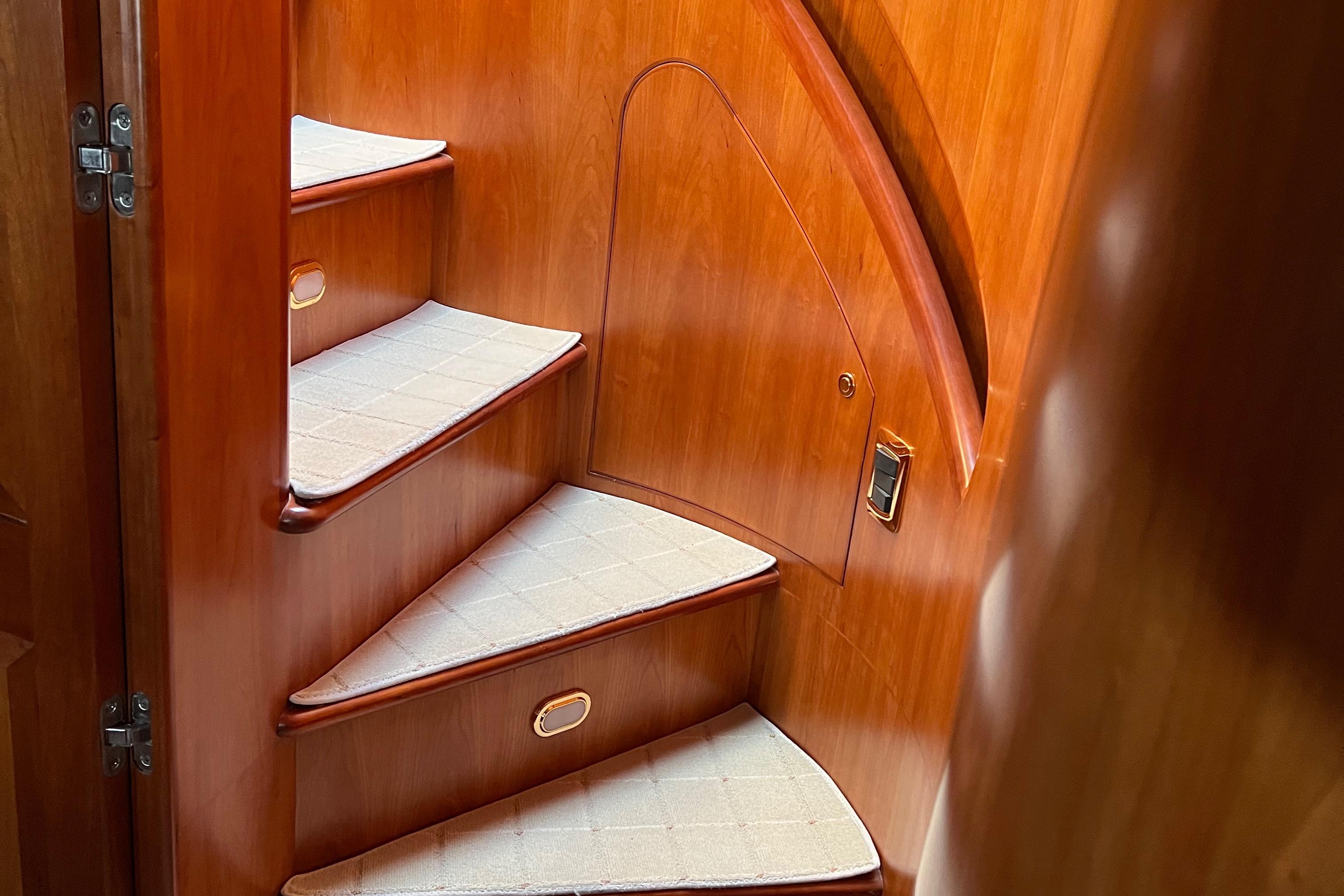 Wooden staircase inside 2006 President 63 Pilot House yacht.