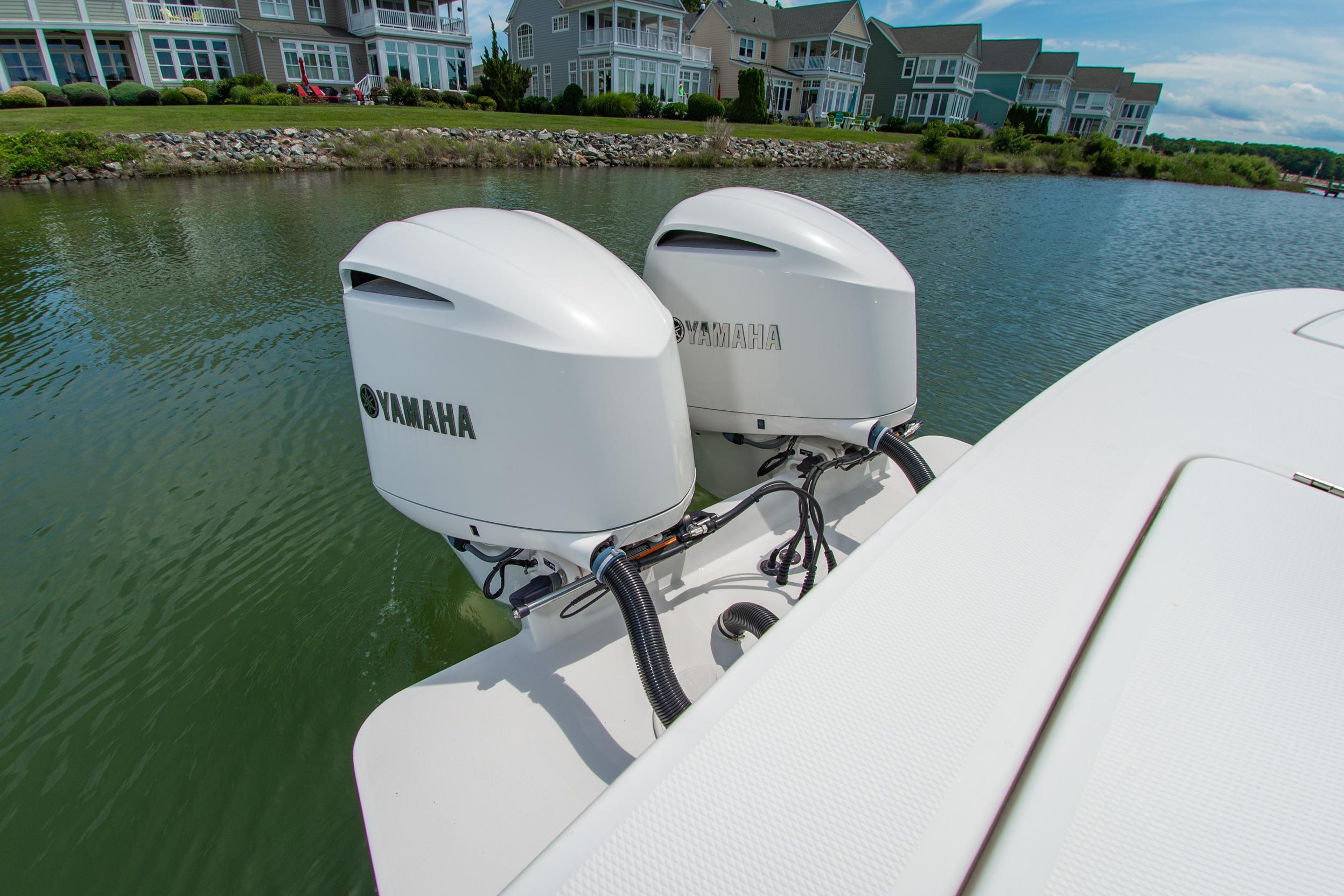 2019 Regulator 31 boat with dual Yamaha outboard engines on a calm waterway.