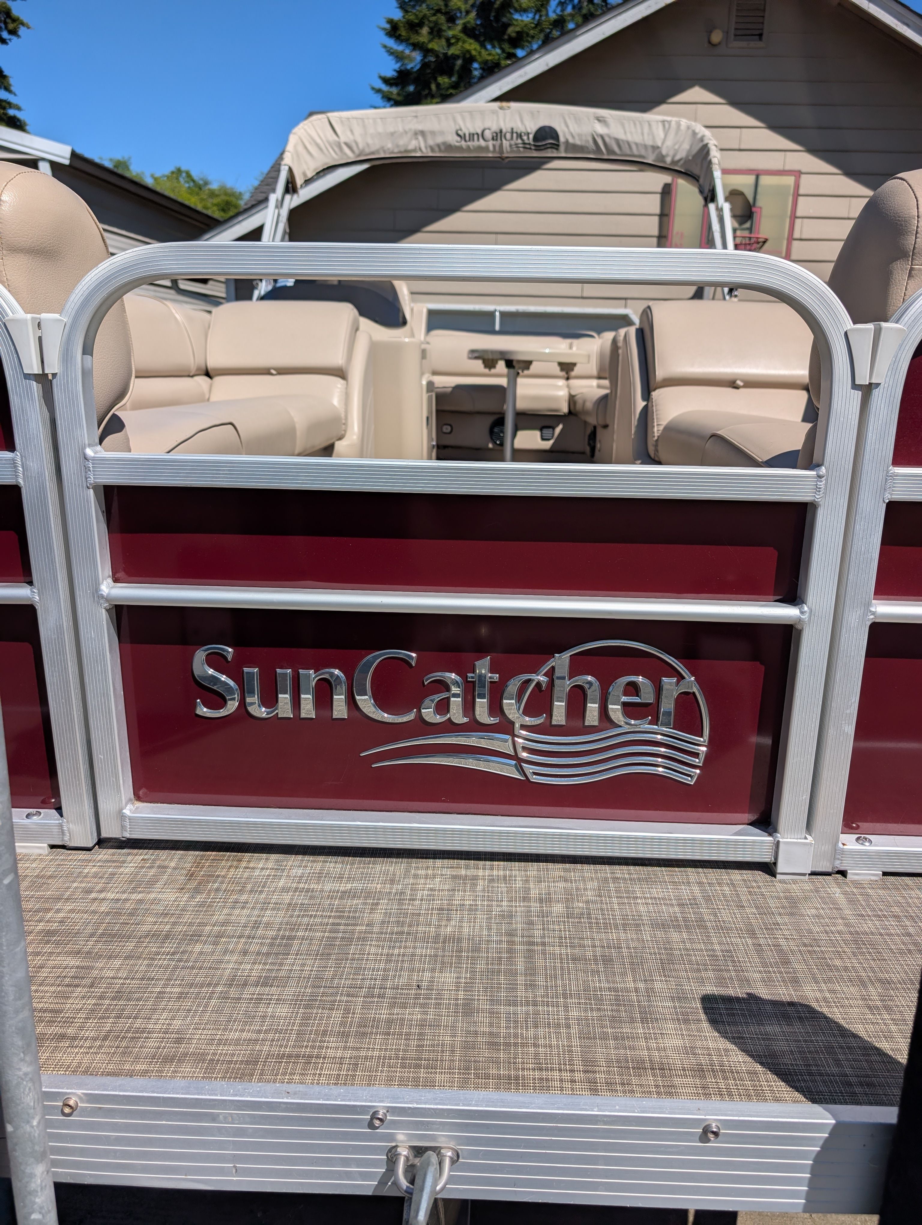 A 2016 SunCatcher V322 GX pontoon boat with beige seating and a sunshade.