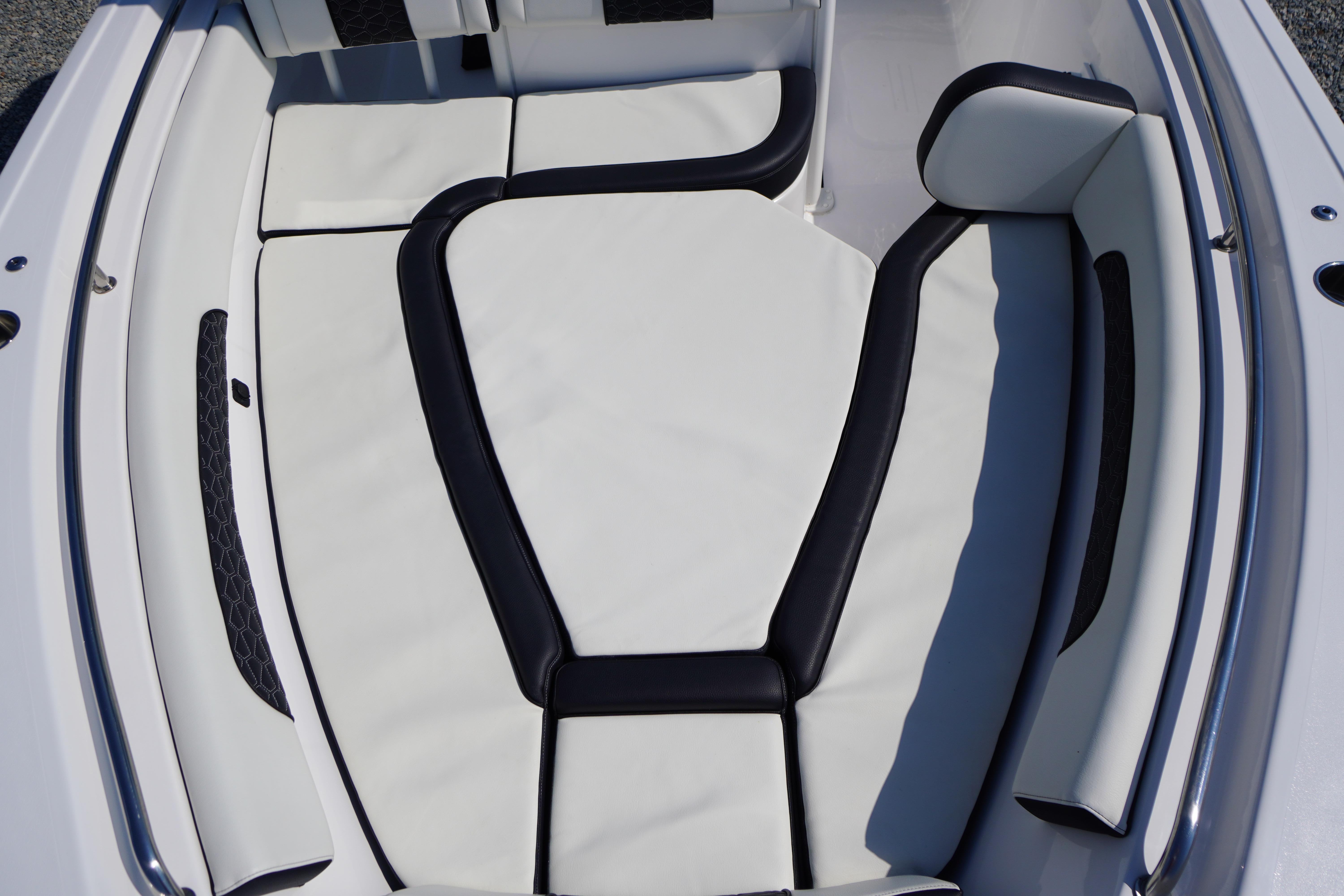 2025 Tidewater 232 SS boat interior with white and black cushioned seating.