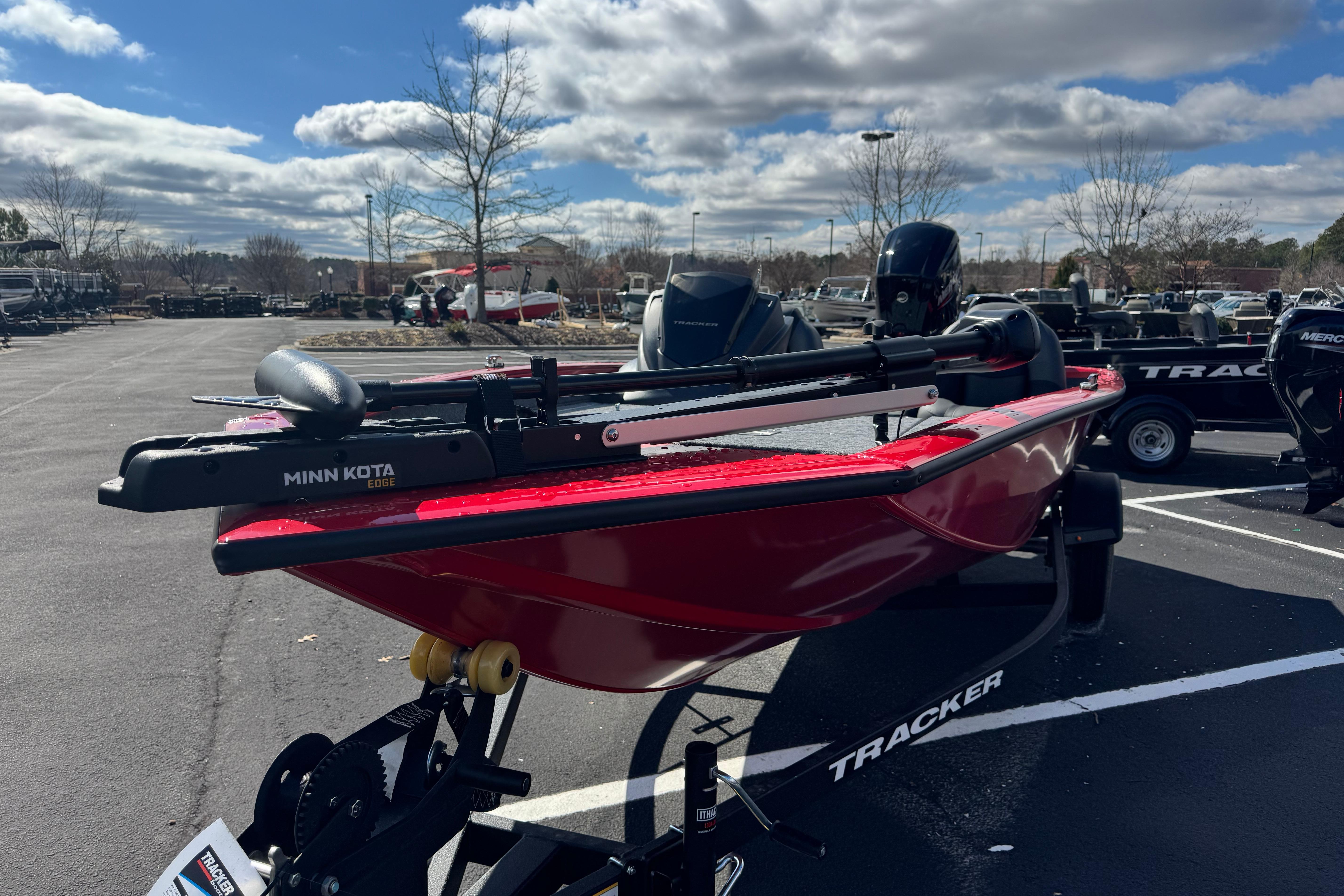 2026 Tracker Pro Team 175 boat with Minn Kota motor in parking lot.