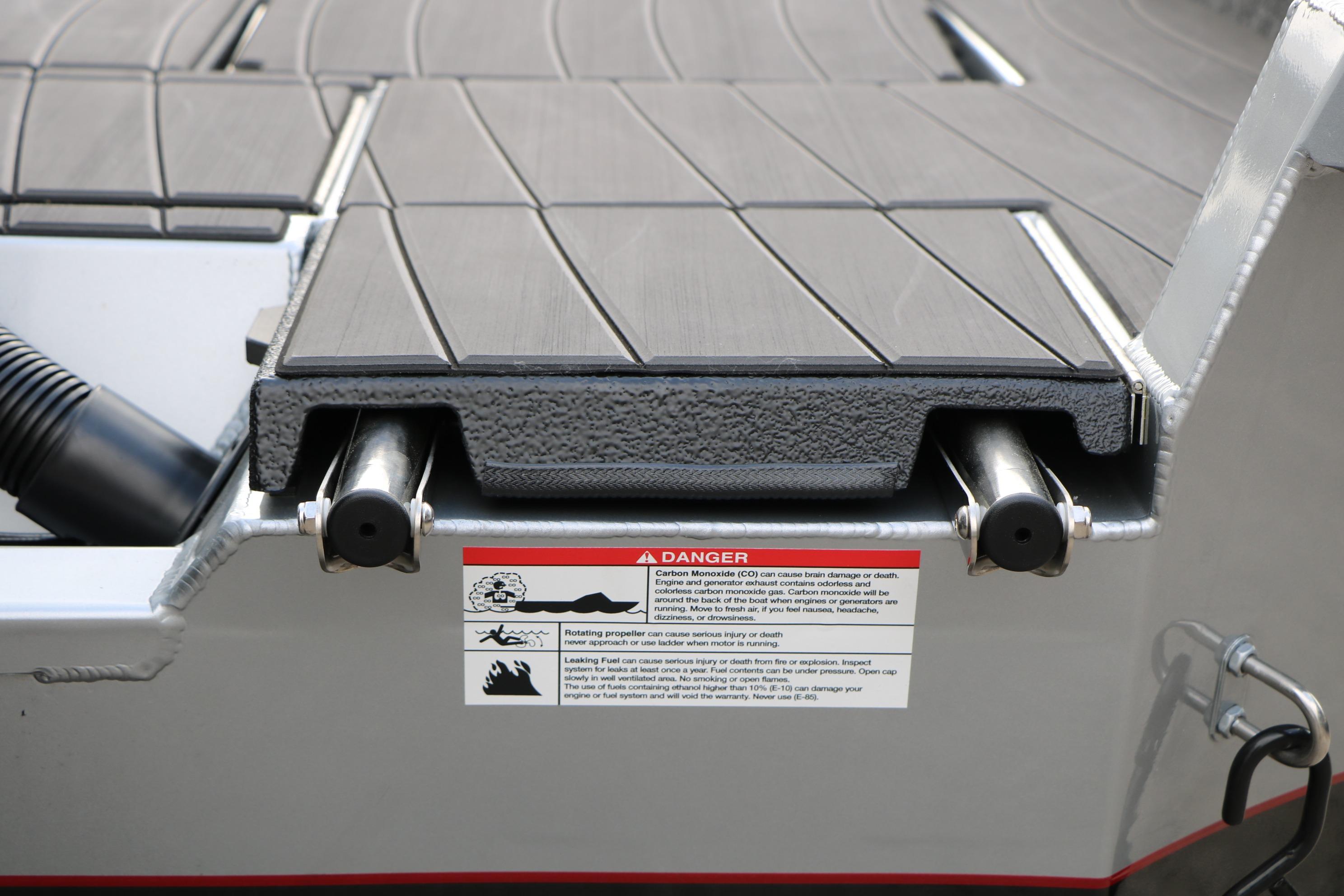 2026 Vexus ADX 190 boat deck with safety warning label and metal fittings.