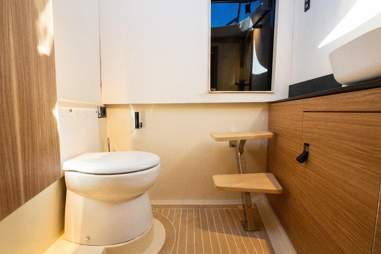 Modern bathroom interior in 2025 AlCustom LIPARI 31 yacht, featuring wood accents and compact design.