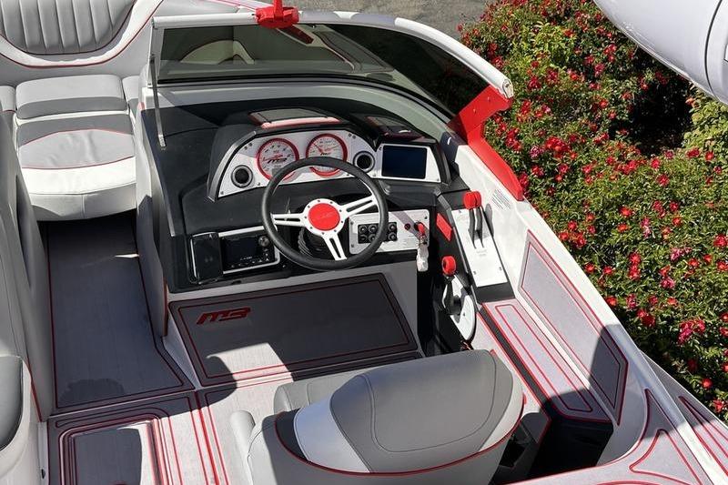 2023 MB SPORTS F22 Tomcat Alpha boat interior with sleek design and modern dashboard.