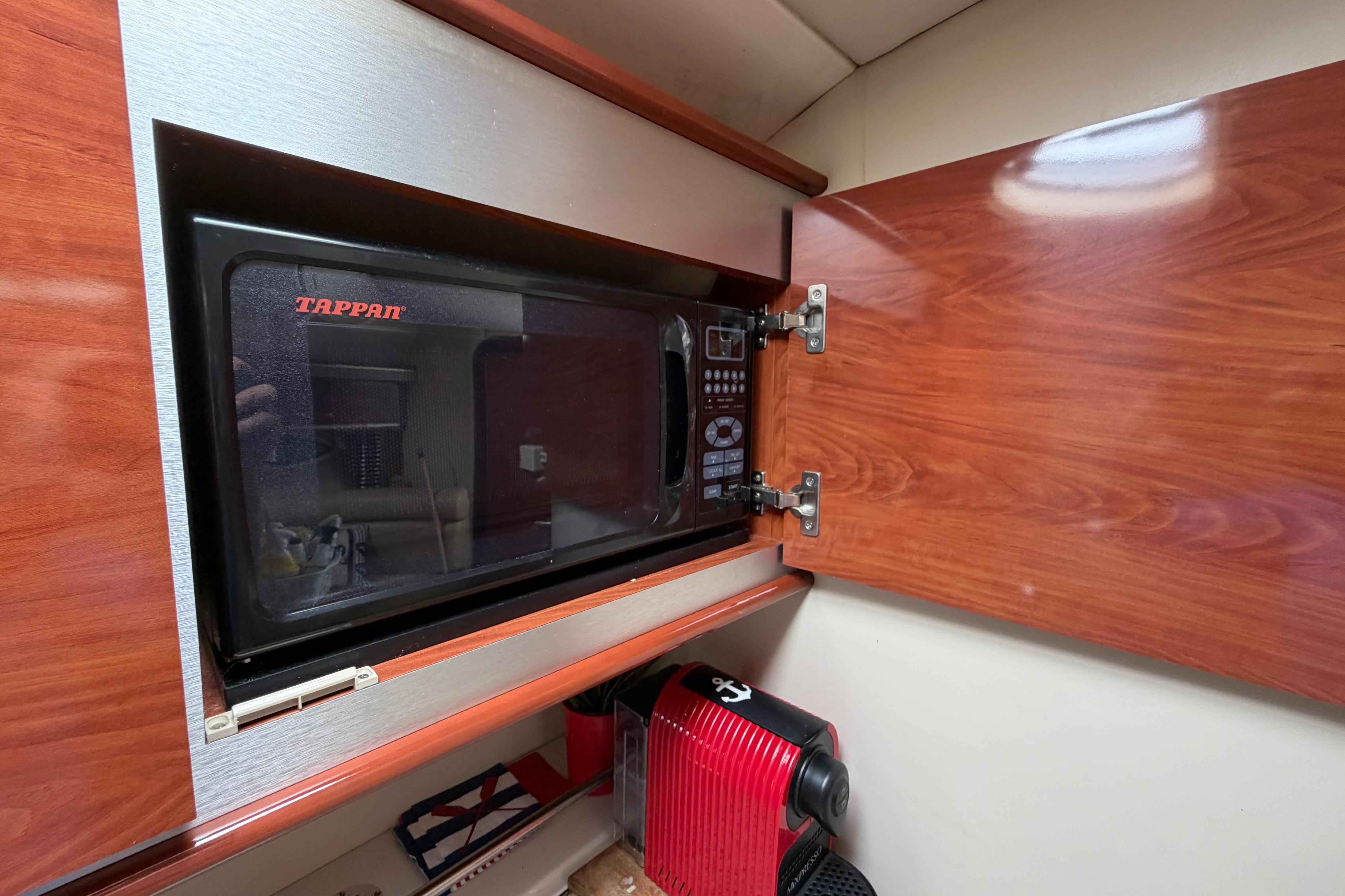 Microwave and coffee maker in 2007 Monterey 350 Sport Yacht kitchen cabinet.