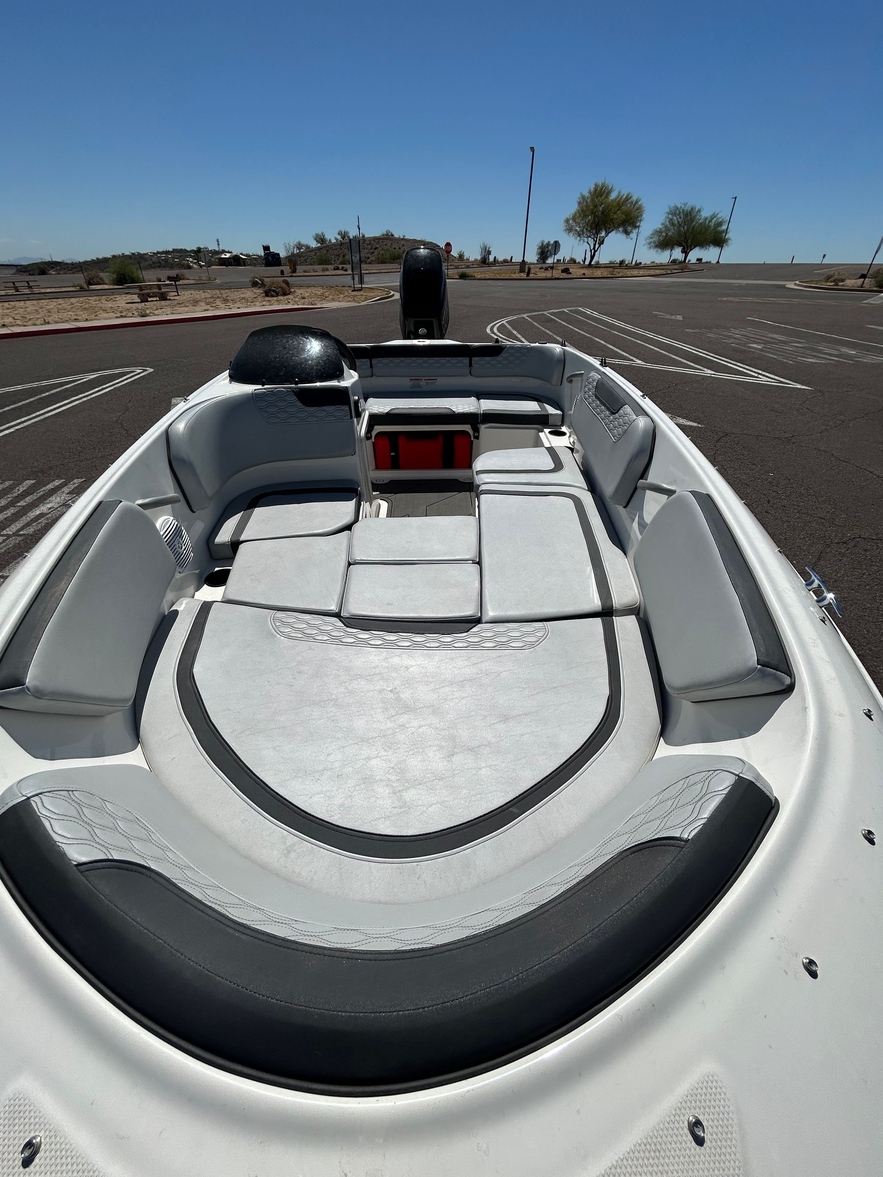 The image shows the interior of a 2021 Bayliner M-15 boat with gray and white seating.