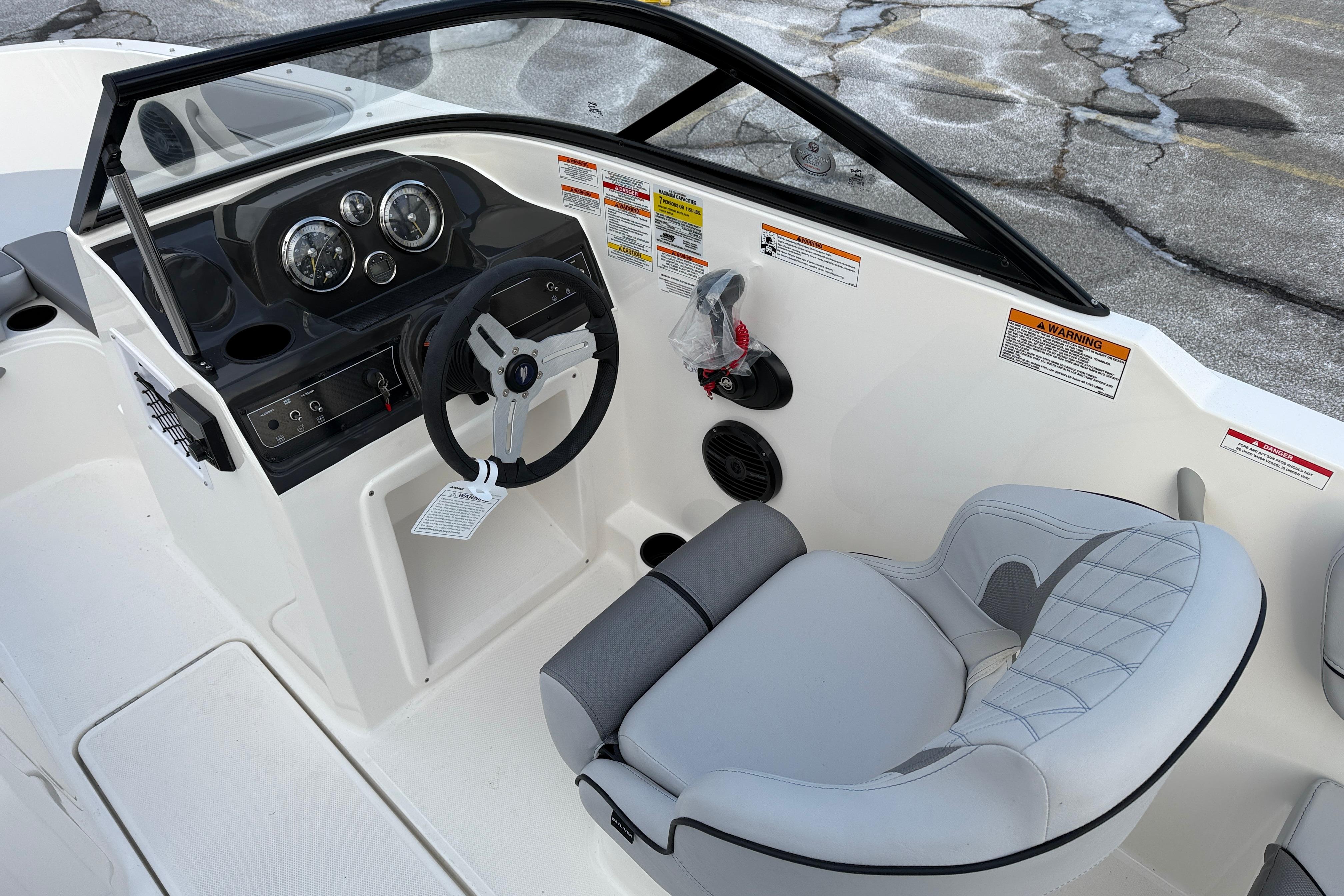 2026 Bayliner VR4 Bowrider OB cockpit with steering wheel and gauges, featuring modern design.