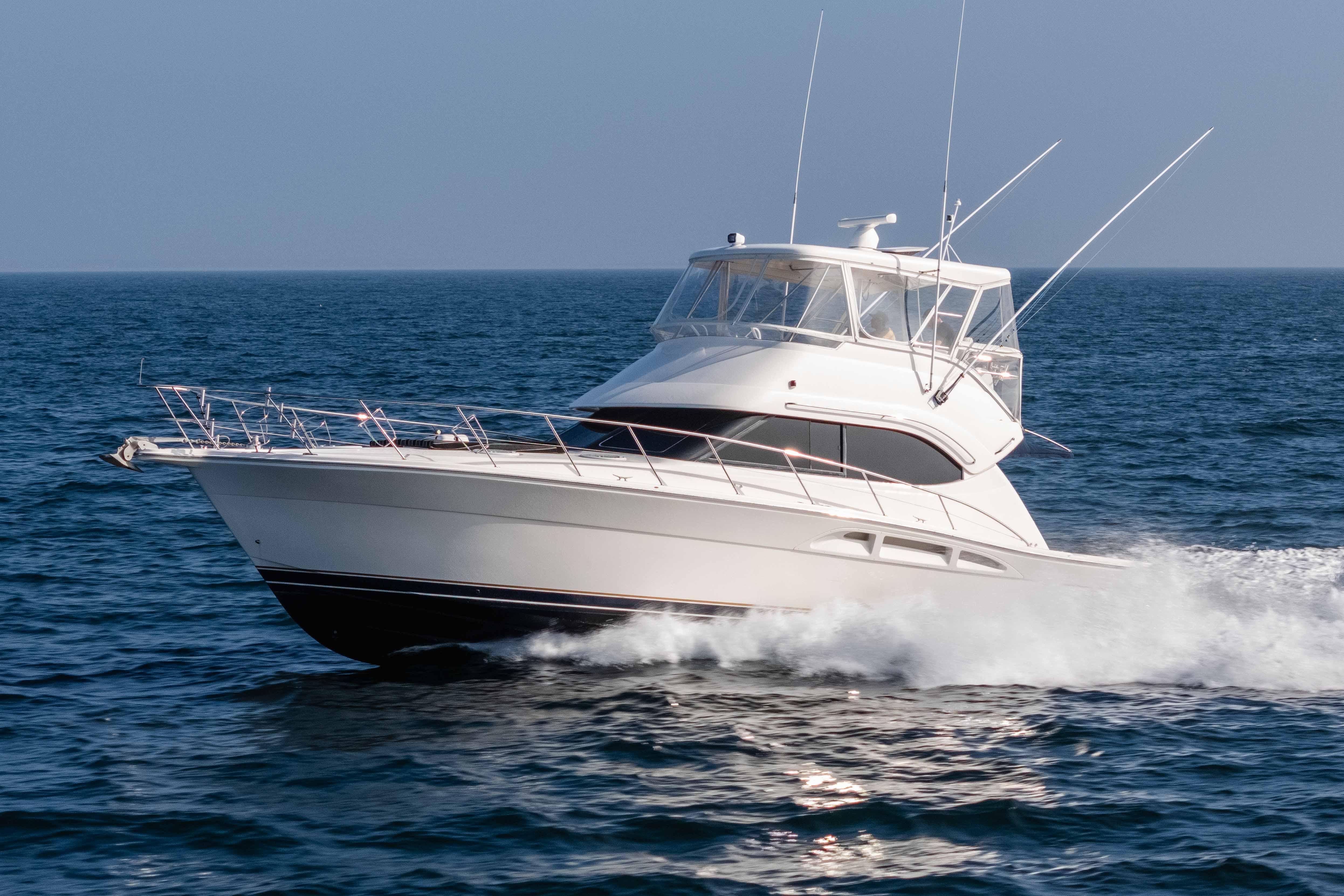 2005 Riviera 47 Convertible yacht cruising on open sea.
