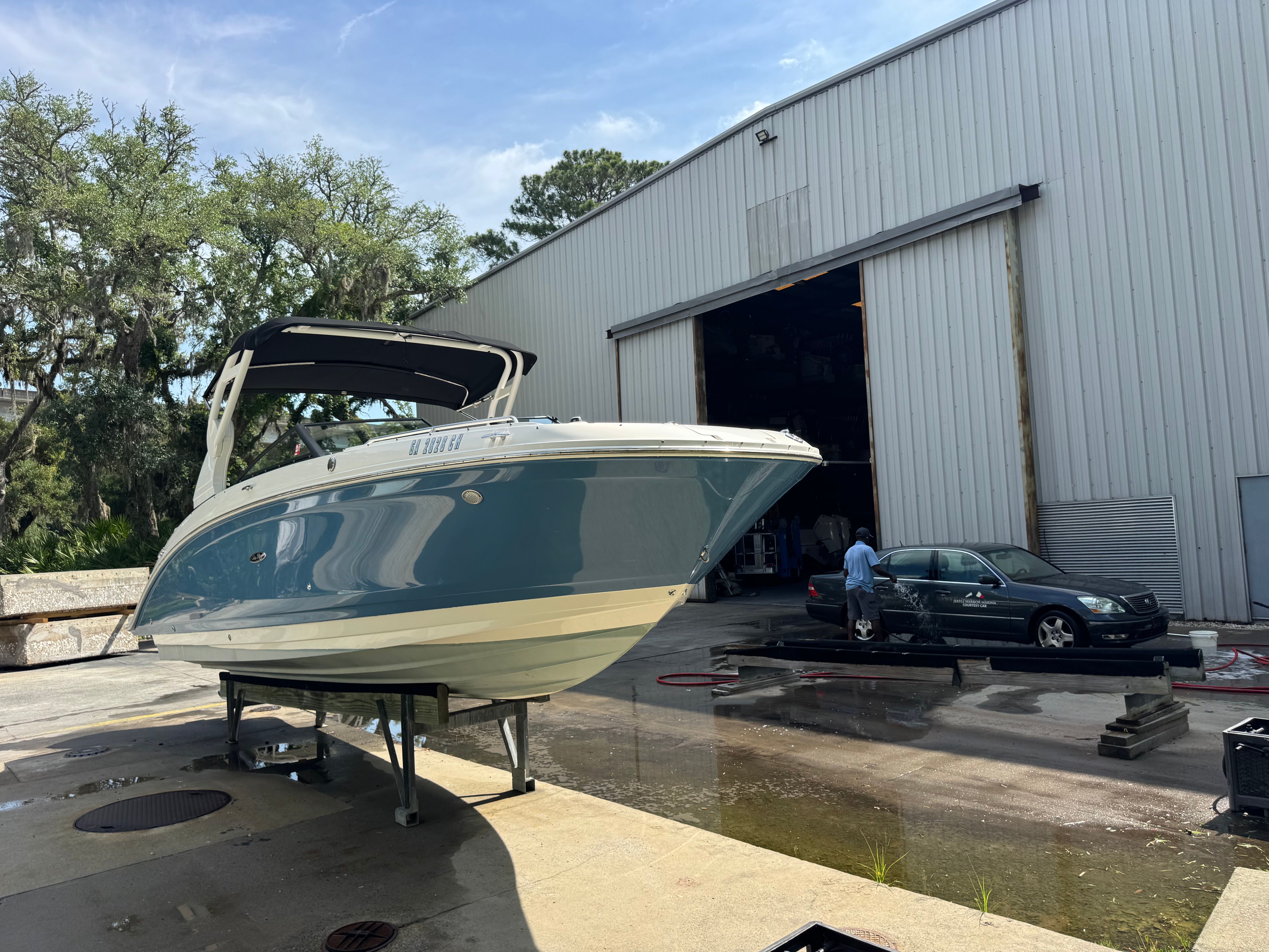 2020 Sea Ray SDX 270 Outboard parked outside warehouse.