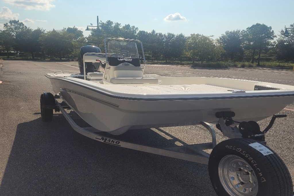 2026 Mako Pro Skiff 17 CC boat on trailer in sunny parking lot.