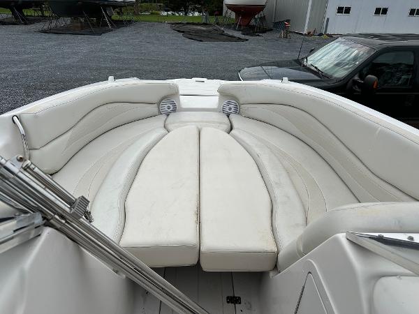 2004 Starcraft Aurora 2410 boat interior with white cushioned seating.