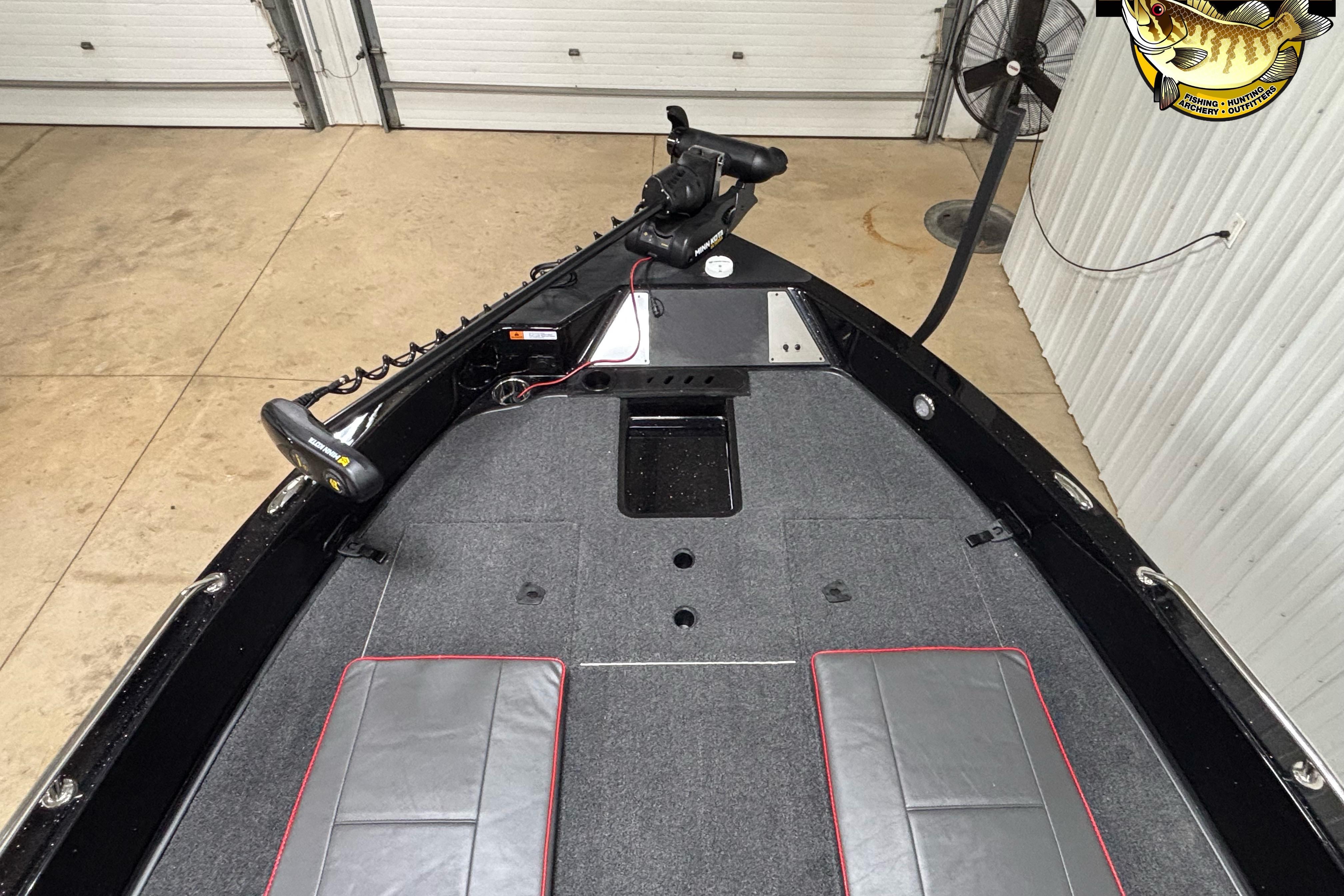 2026 Triton 206 Allure boat interior with gray carpet and fishing equipment.