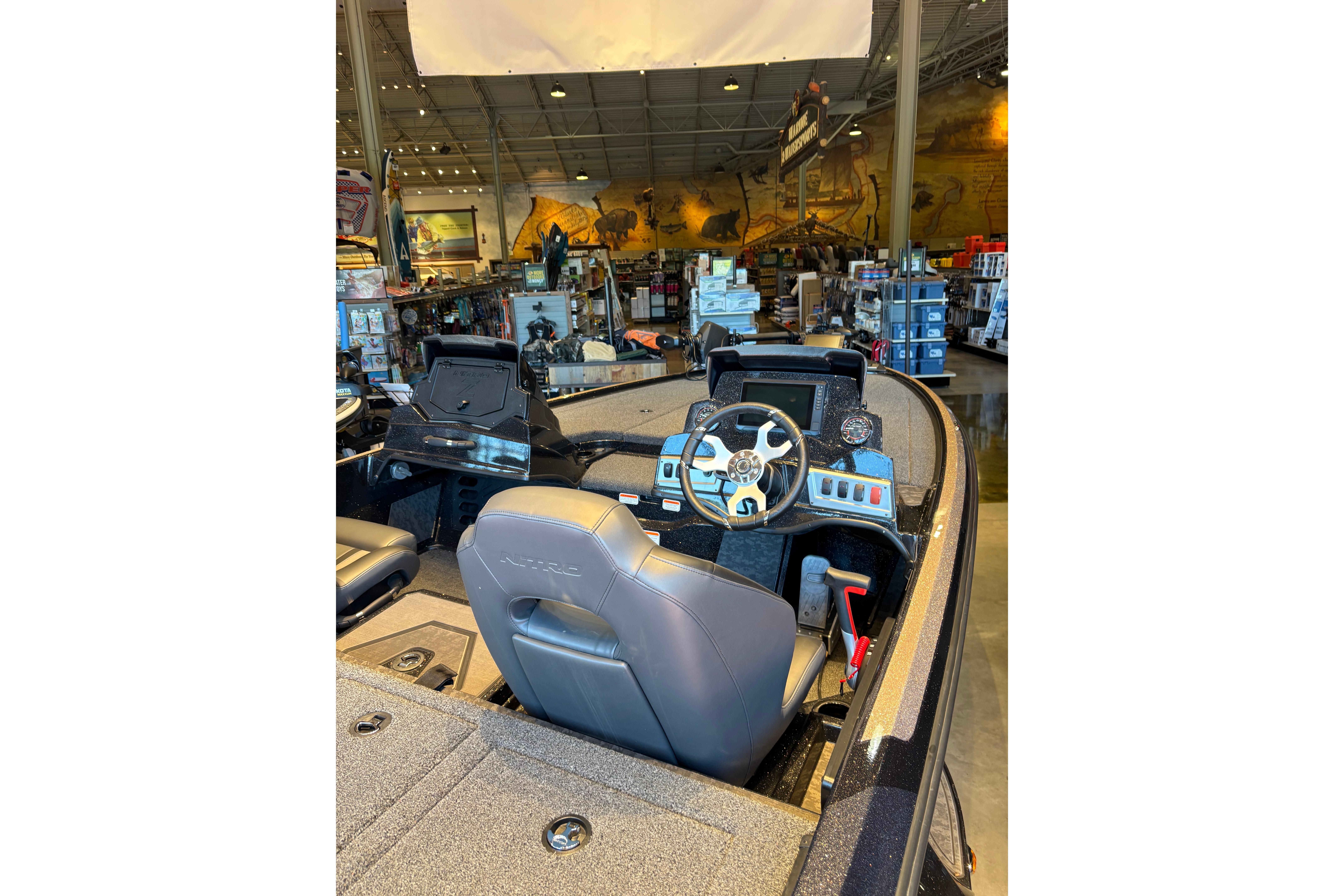 2026 Nitro Z19 XL Pro boat interior with steering wheel and dashboard in showroom.
