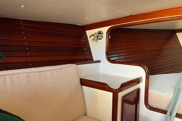 Interior of a 2006 Morris 36 boat with polished wood and beige upholstery.