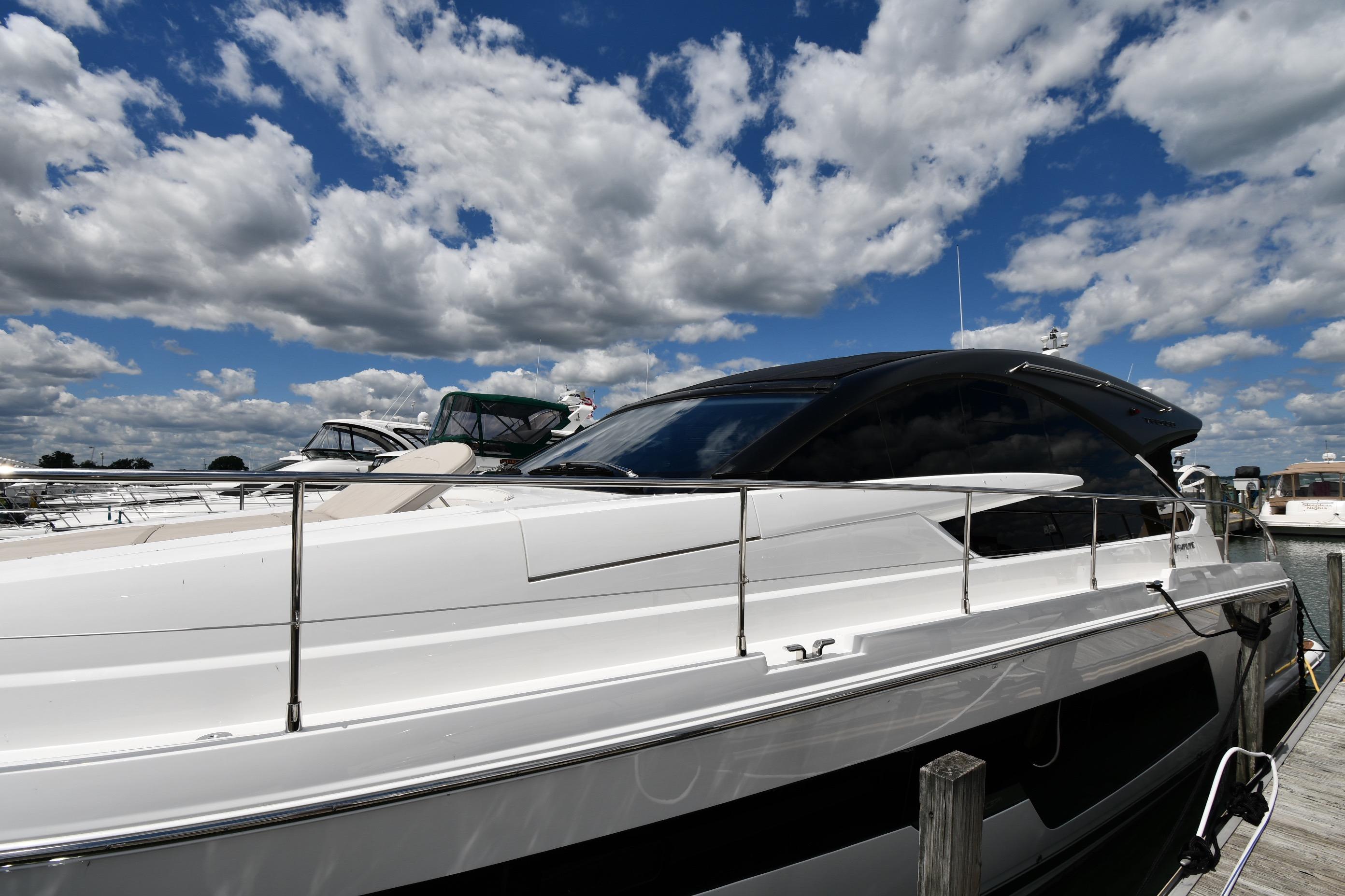 2024 Fairline G50 Targa yacht docked under a partly cloudy sky.
