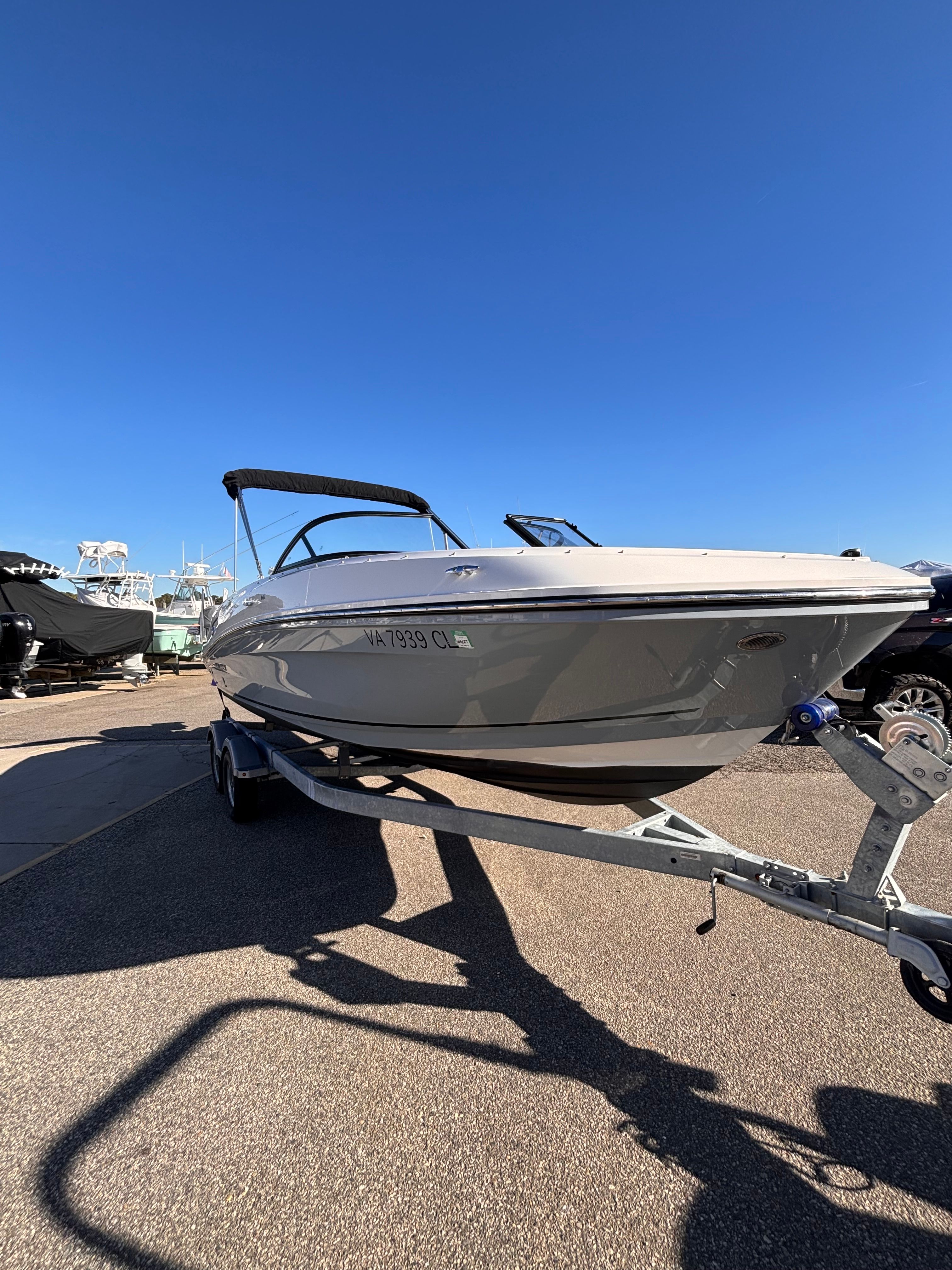 2024 Bayliner VR6 Bowrider OB on trailer, blue sky.