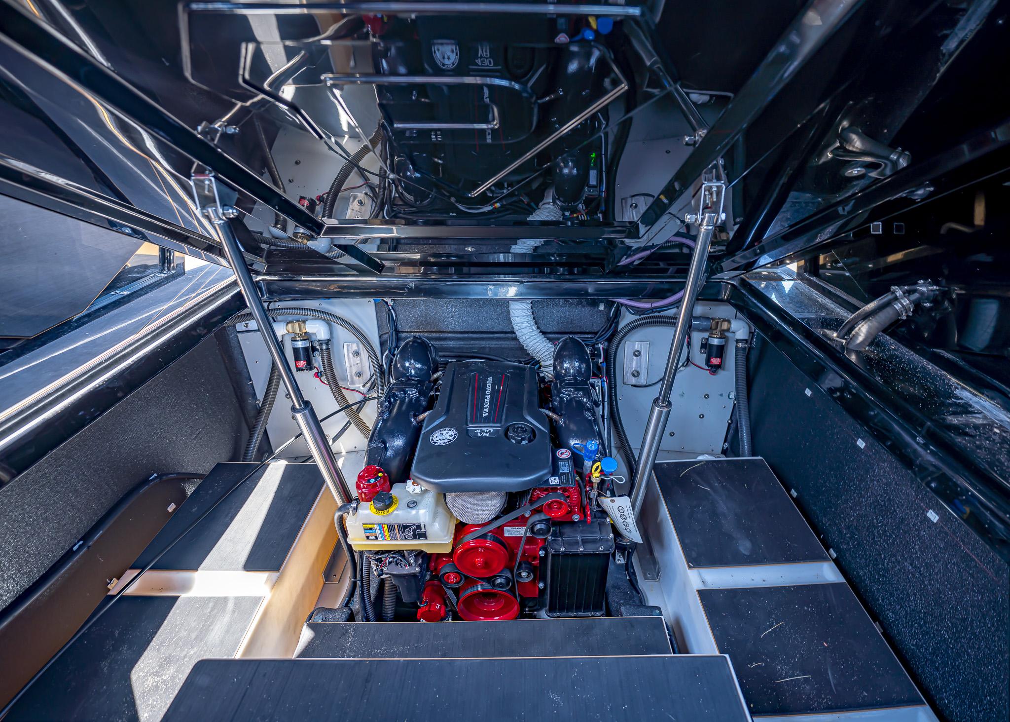 Engine compartment of a 2025 Paradigm 236 boat, showcasing modern mechanical components.