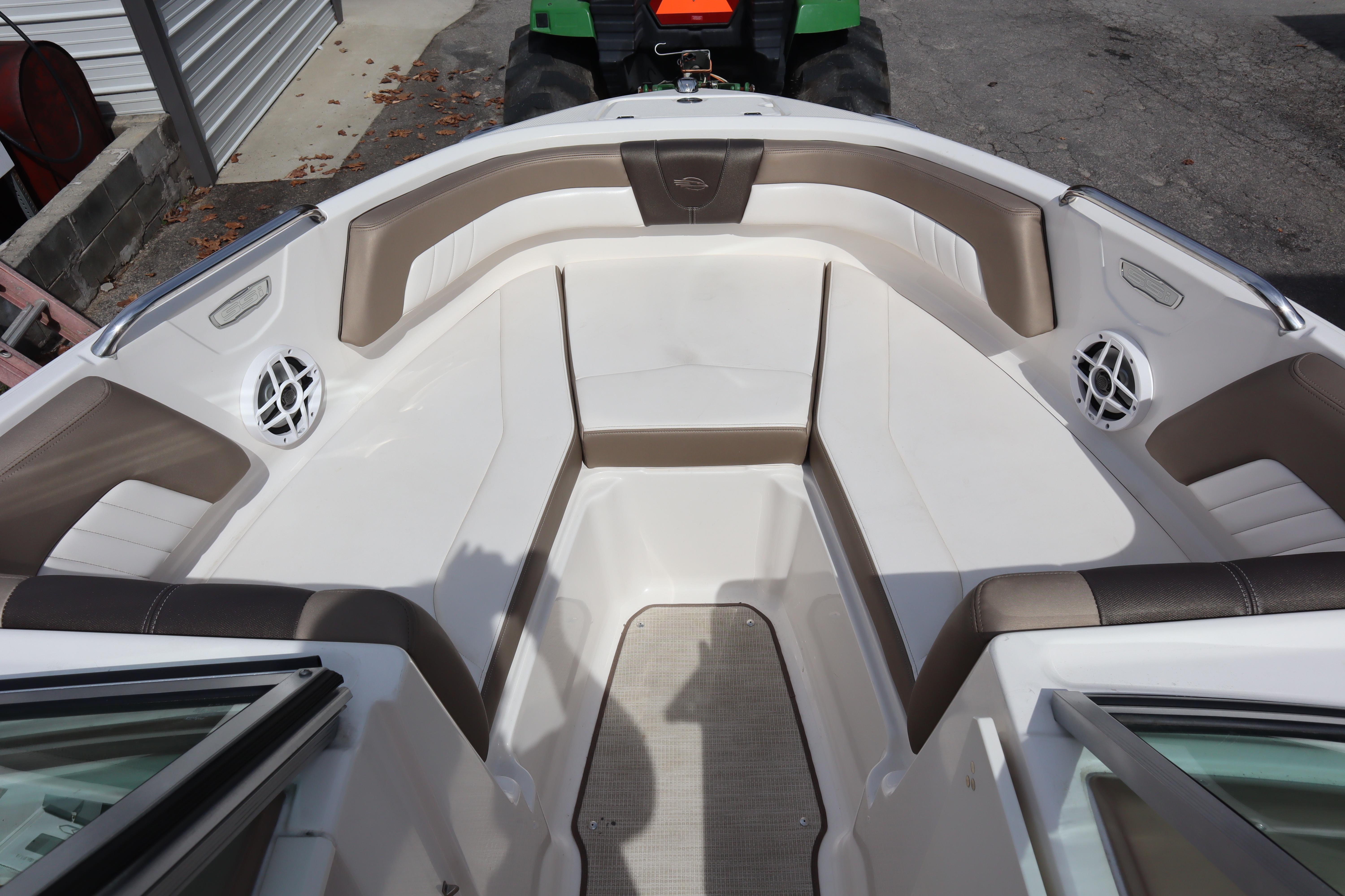 2021 Chaparral 21 SSi boat interior with brown and white seating, featuring speakers.